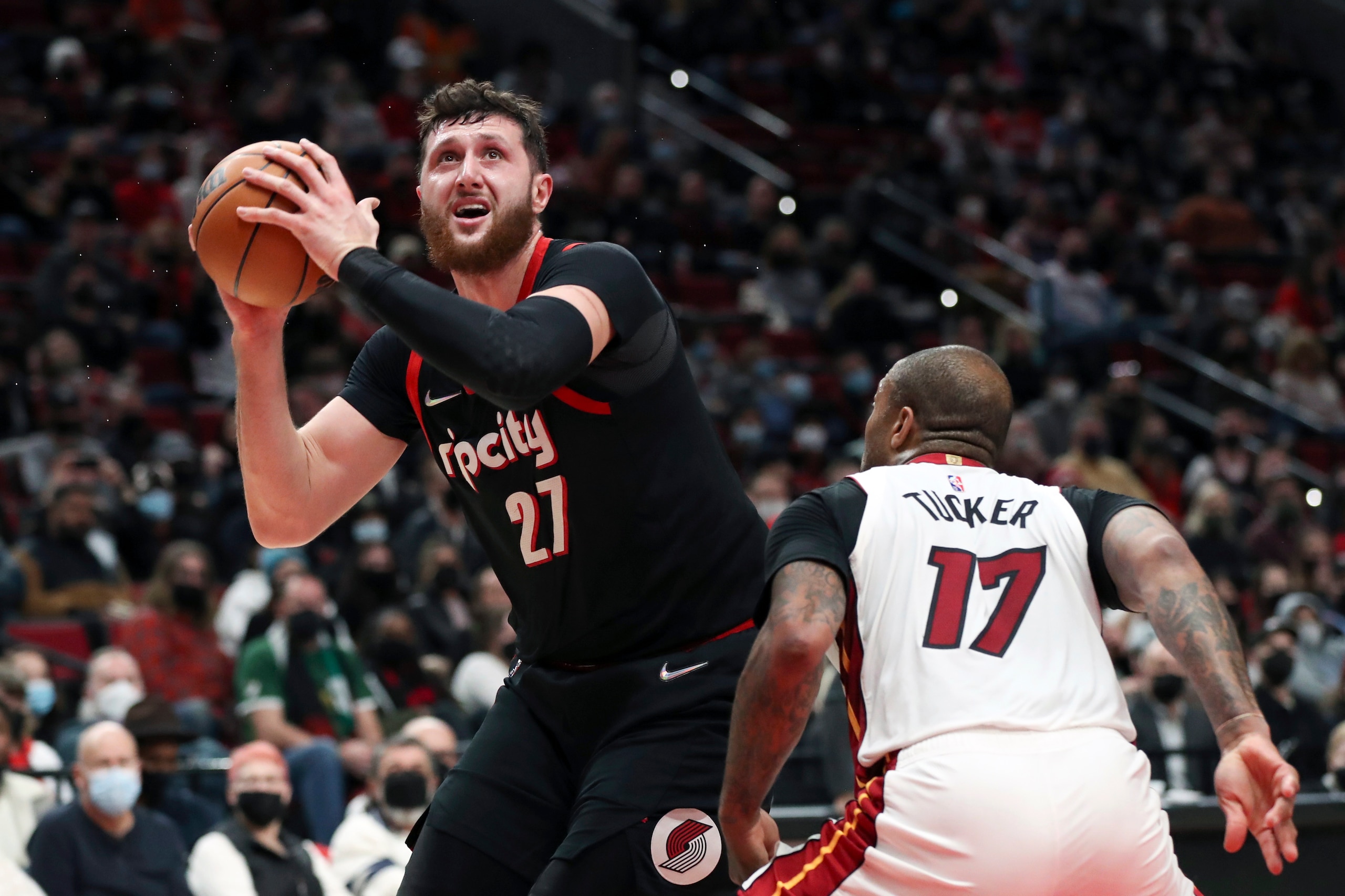 Portland Trail Blazers center Jusuf Nurkic shoots over Miami Heat forward PJ Tucker during the first half of an NBA basketball game in Portland, Ore., Wednesday, Jan. 5, 2022. (AP Photo/Amanda Loman)