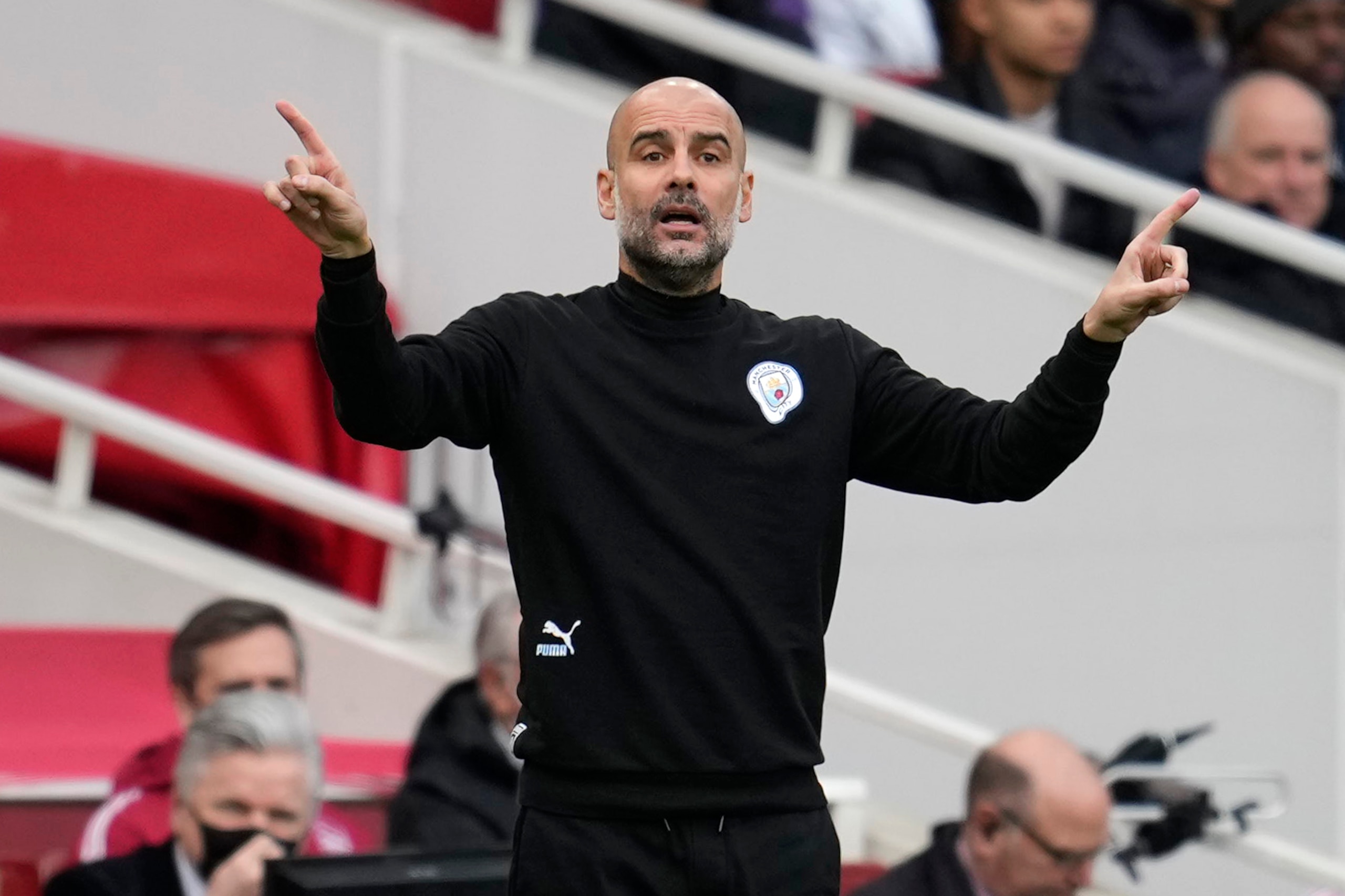 Manchester City's head coach Pep Guardiola gestures during the Premier League soccer match between Arsenal and Manchester City at the Emirates Stadium, in London, England, Saturday Jan. 1, 2022. (AP Photo/Matt Dunham)