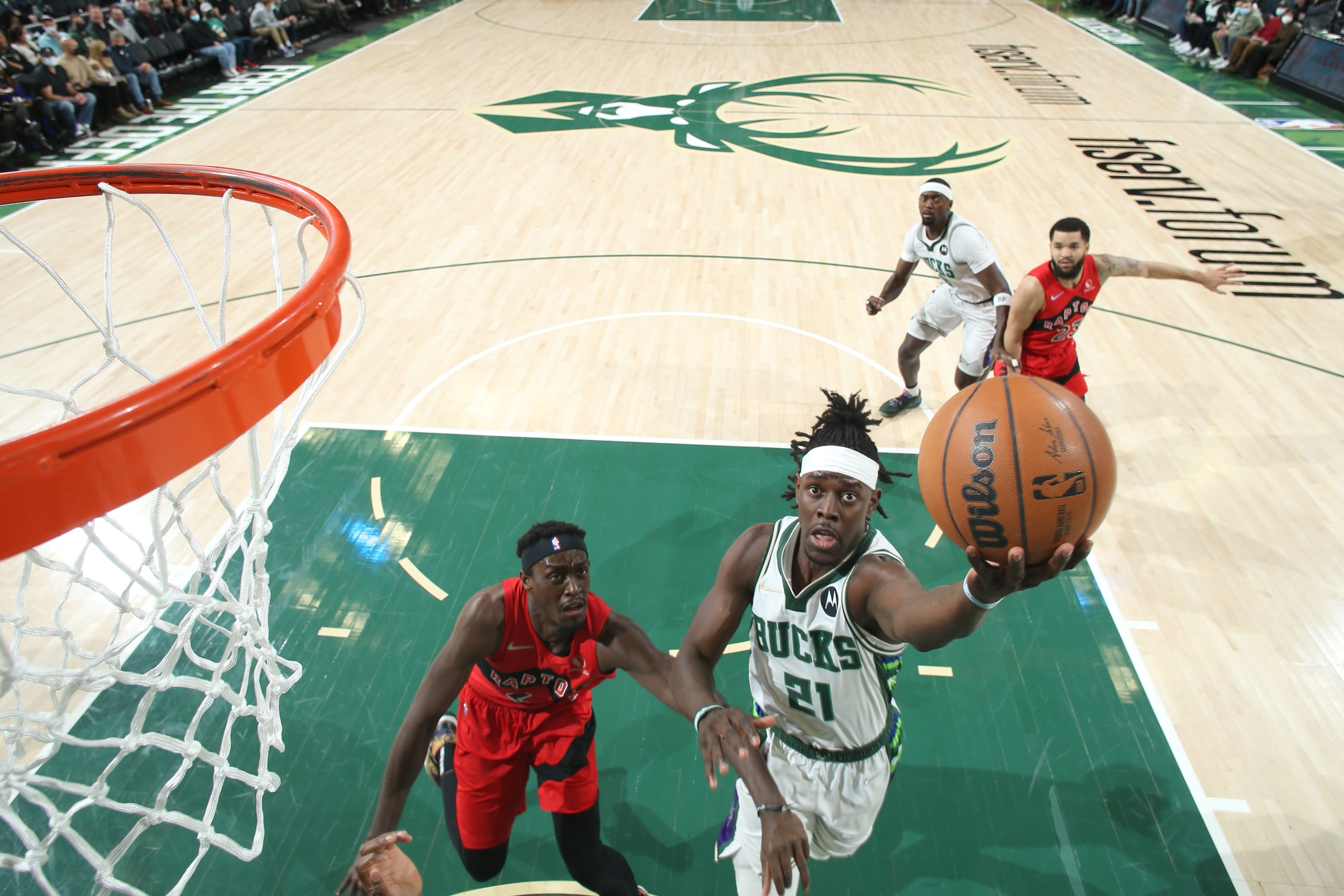 MILWAUKEE, WI - JANUARY 5: Jrue Holiday #21 of the Milwaukee Bucks drives to the basket during the game against the Toronto Raptors on January 5, 2022 at the Fiserv Forum Center in Milwaukee, Wisconsin. NOTE TO USER: User expressly acknowledges and agrees that, by downloading and or using this Photograph, user is consenting to the terms and conditions of the Getty Images License Agreement. Mandatory Copyright Notice: Copyright 2022 NBAE (Photo by Gary Dineen/NBAE via Getty Images). MILWAUKEE, WI - JANUARY 5: Jrue Holiday #21 of the Milwaukee Bucks drives to the basket during the game against the Toronto Raptors on January 5, 2022 at the Fiserv Forum Center in Milwaukee, Wisconsin. NOTE TO USER: User expressly acknowledges and agrees that, by downloading and or using this Photograph, user is consenting to the terms and conditions of the Getty Images License Agreement. Mandatory Copyright Notice: Copyright 2022 NBAE (Photo by Gary Dineen/NBAE via Getty Images).
