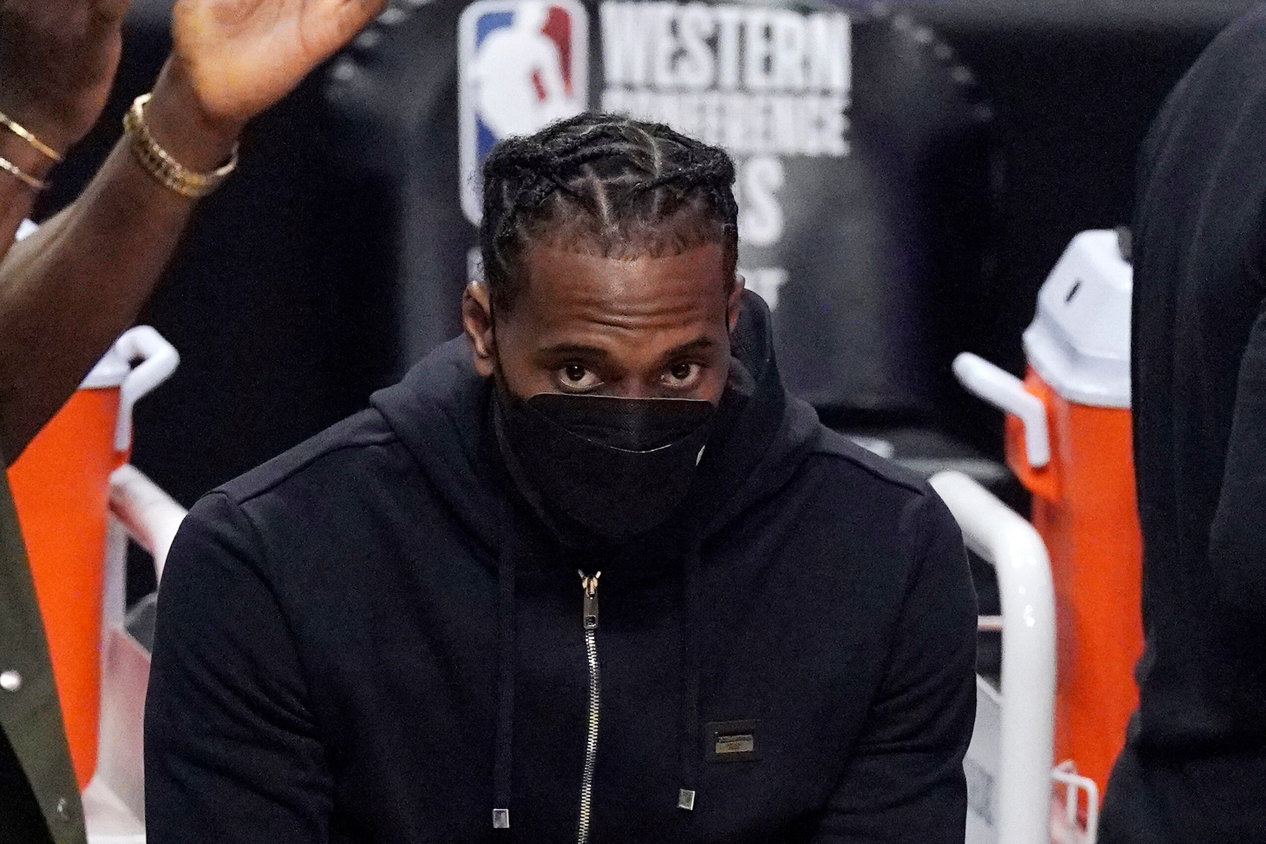 FILE - Los Angeles Clippers forward Kawhi Leonard sits on the bench during the first half in Game 6 of the NBA basketball Western Conference Finals against the Phoenix Suns in Los Angeles, in this Wednesday, June 30, 2021, file photo. The biggest question hanging over the Clippers is when Leonard will return. Will he work his way back from knee surgery to repair a partially torn ACL before the end of the regular season? Or for the playoffs? Or remain out until next season?Even he isn't sure. (AP Photo/Mark J. Terrill, File)