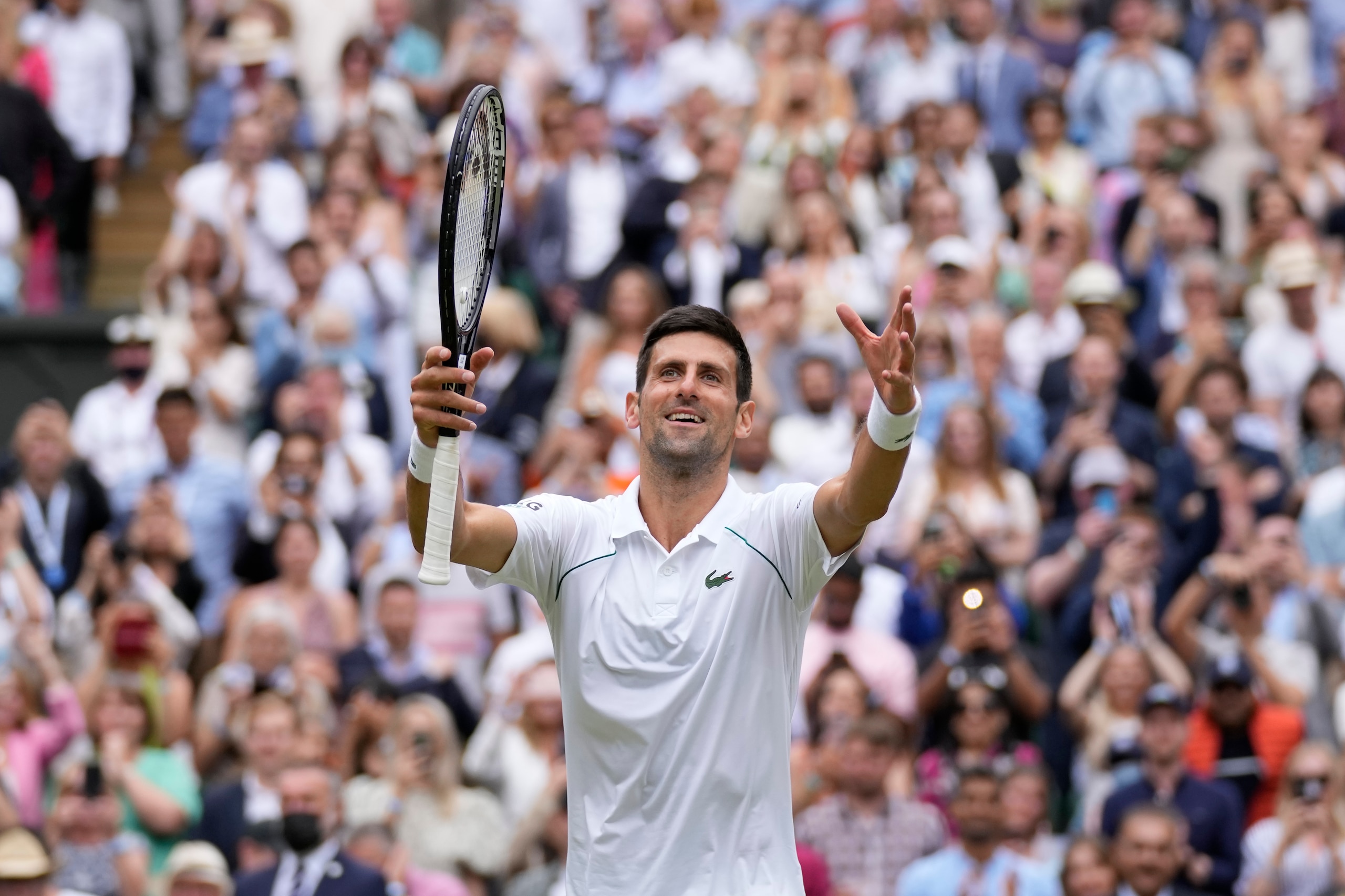 FILE - Serbia's Novak Djokovic celebrates toward the crowd after defeating Italy's Matteo Berrettini in the men's singles final on day thirteen of the Wimbledon Tennis Championships in London, July 11, 2021. The Australian government has denied No. 1-ranked Novak Djokovic entry to defend his title in the year's first tennis major and canceled his visa because he failed to meet the requirements for an exemption to the country's COVID-19 vaccination rules. (AP Photo/Kirsty Wigglesworth, File) FILE - Serbia's Novak Djokovic celebrates toward the crowd after defeating Italy's Matteo Berrettini in the men's singles final on day thirteen of the Wimbledon Tennis Championships in London, July 11, 2021. The Australian government has denied No. 1-ranked Novak Djokovic entry to defend his title in the year's first tennis major and canceled his visa because he failed to meet the requirements for an exemption to the country's COVID-19 vaccination rules. (AP Photo/Kirsty Wigglesworth, File)