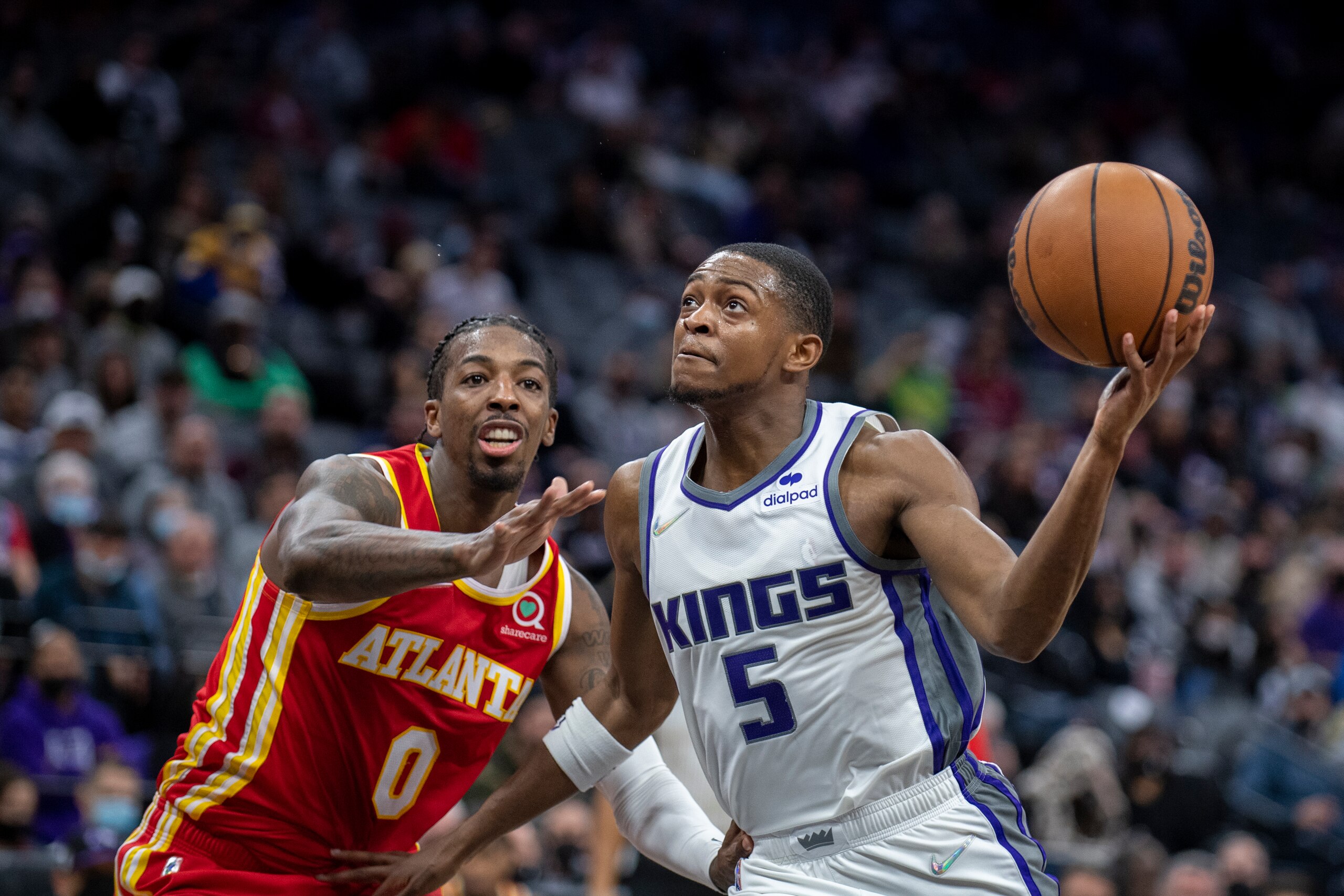 Sacramento Kings guard De'Aaron Fox (5) gets around Atlanta Hawks guard Delon Wright (0) on a drive to the basket during the second half of an NBA basketball game in Sacramento, Calif., Wednesday, Jan. 5, 2022. The Hawks won 108-102. (AP Photo/José Luis Villegas)