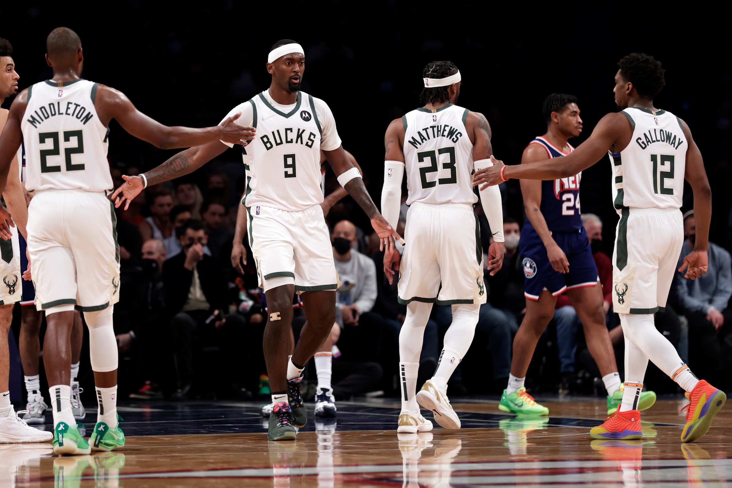 Milwaukee Bucks center Bobby Portis (9) reacts with teammates after being fouled by the Brooklyn Nets during the first half of an NBA basketball game Friday, Jan. 7, 2022, in New York. (AP Photo/Adam Hunger)
