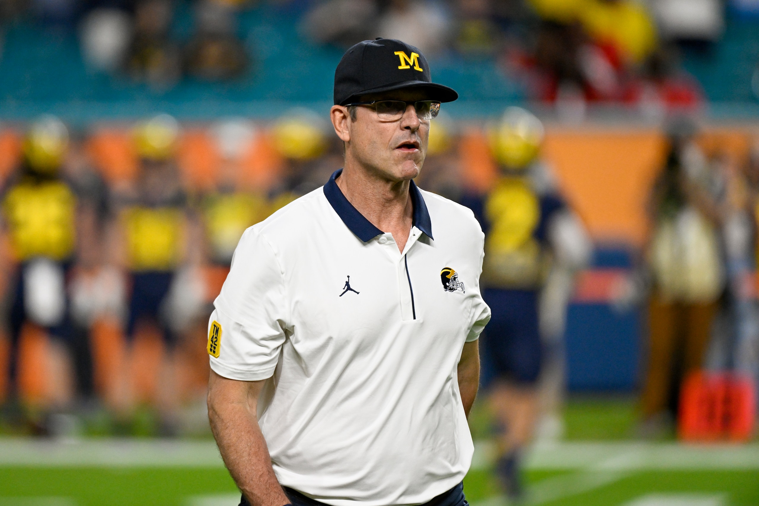 MIAMI GARDENS, FL - DECEMBER 31: Michigan Wolverines head coach Jim Harbaugh on the field before the start of the College Football Playoff Semifinal game between the Georgia Bulldogs and the Michigan Wolverines at the Capital One Orange Bowl on December 31, 2021 at the Hard Rock Stadium in Miami Gardens, FL.  (Photo by Doug Murray/Icon Sportswire via Getty Images)
