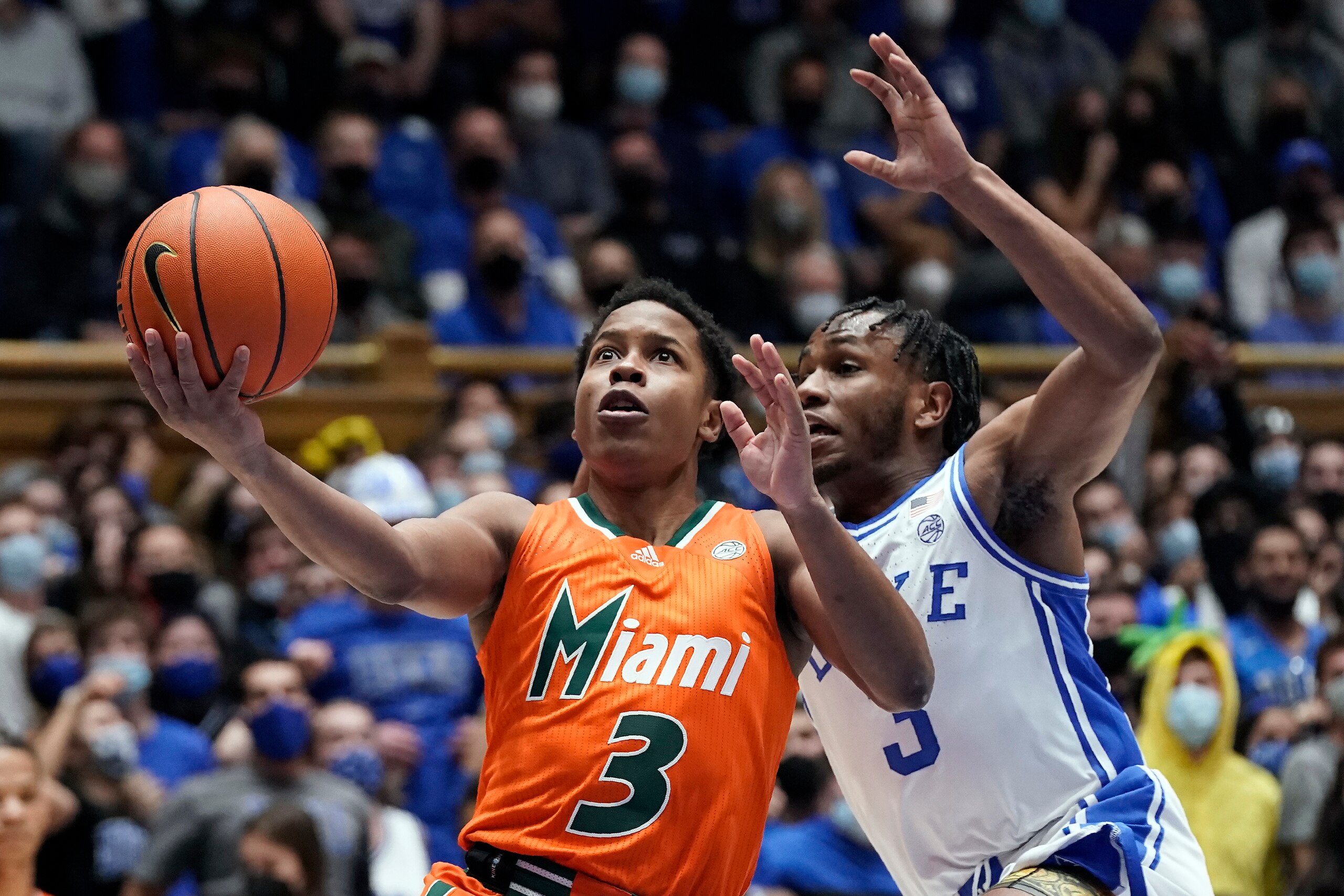Miami guard Charlie Moore, left, drives to the basket while Duke guard Jeremy Roach defends during the first half of an NCAA college basketball game in Durham, N.C., Saturday, Jan. 8, 2022. (AP Photo/Gerry Broome)