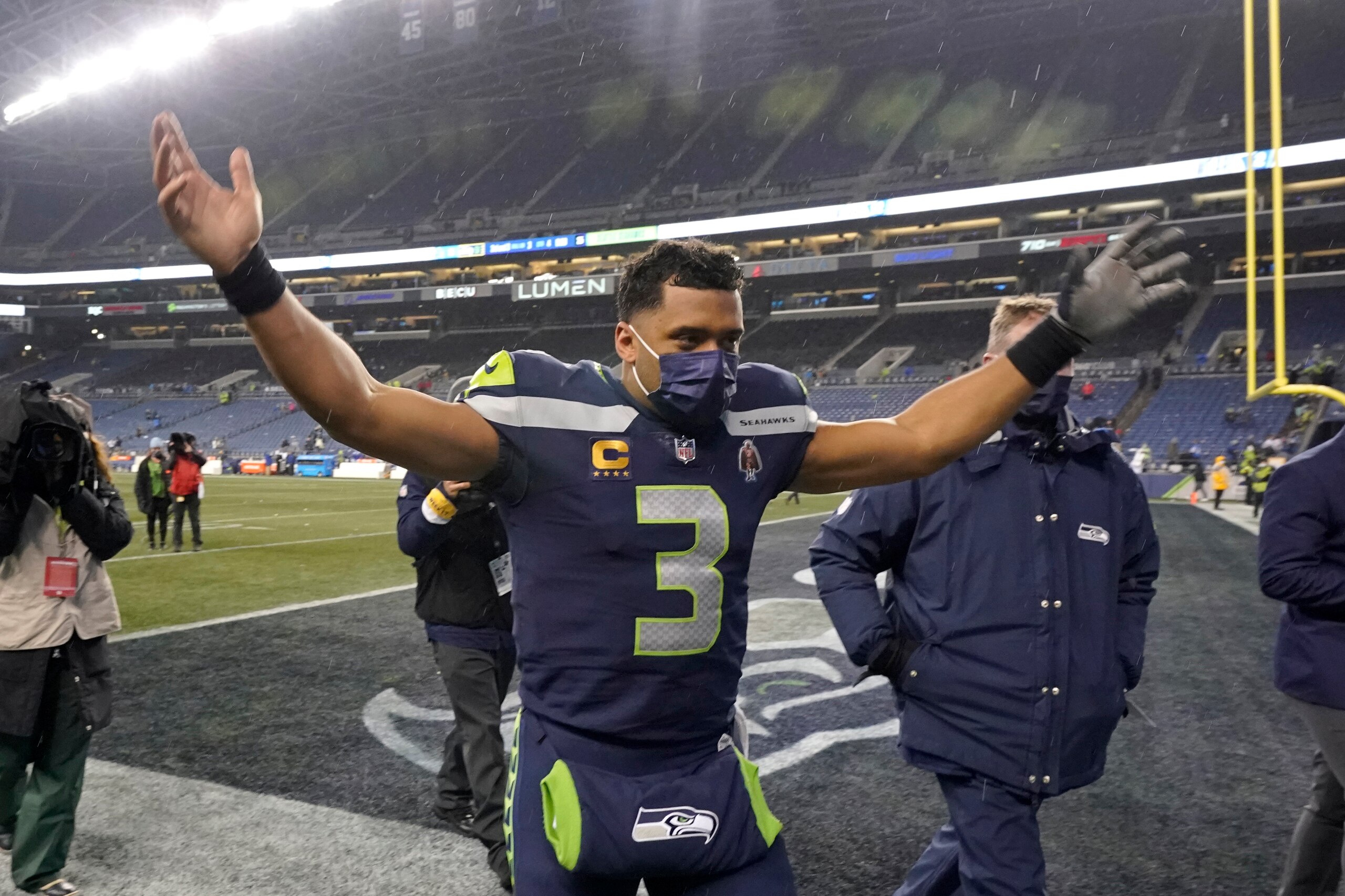 Seattle Seahawks quarterback Russell Wilson (3) reacts to cheers as he leaves the field after an NFL football game against the Detroit Lions, Sunday, Jan. 2, 2022, in Seattle. (AP Photo/Elaine Thompson)