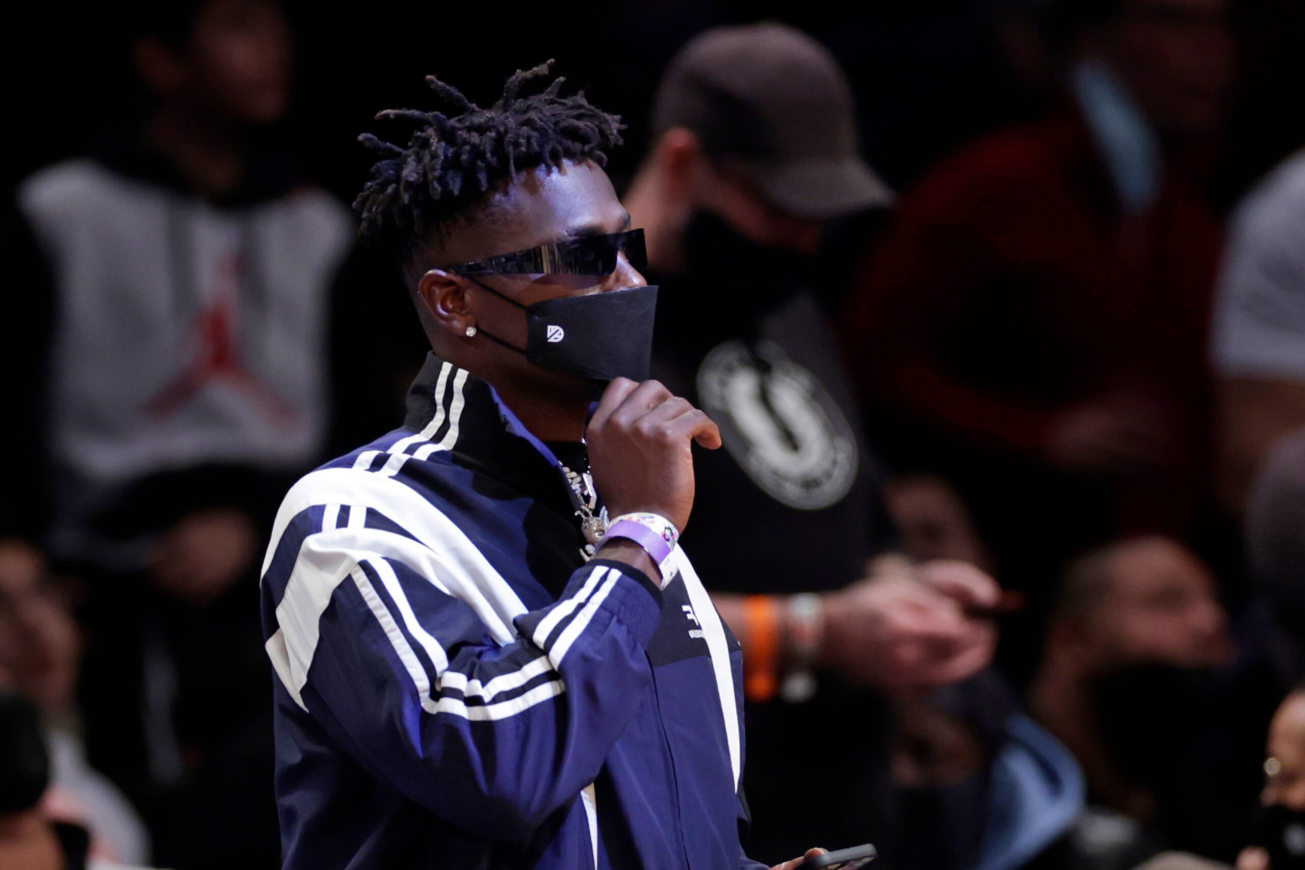 Former Tampa Bay Buccaneers wide receiver Antonio Brown looks on during the second half of an NBA basketball game between the Memphis Grizzlies and the Brooklyn Nets on Monday, Jan. 3, 2022, in New York. The Grizzlies won 118-104. (AP Photo/Adam Hunger)