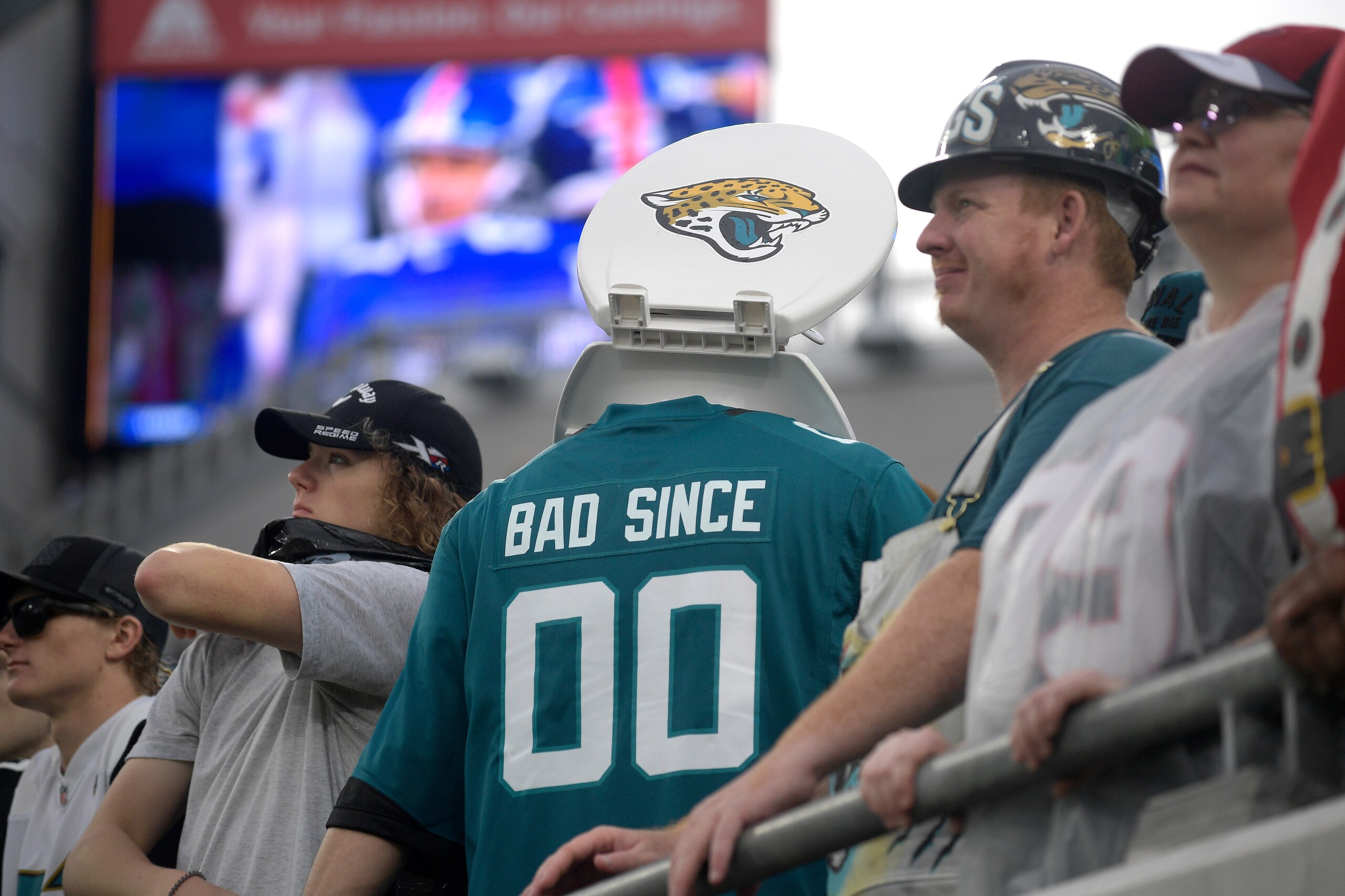 A Jacksonville Jaguars fan wears a toilet seat around his neck in the stands during the second half of an NFL football game against the Houston Texans, Sunday, Dec. 19, 2021, in Jacksonville, Fla. (AP Photo/Phelan M. Ebenhack)