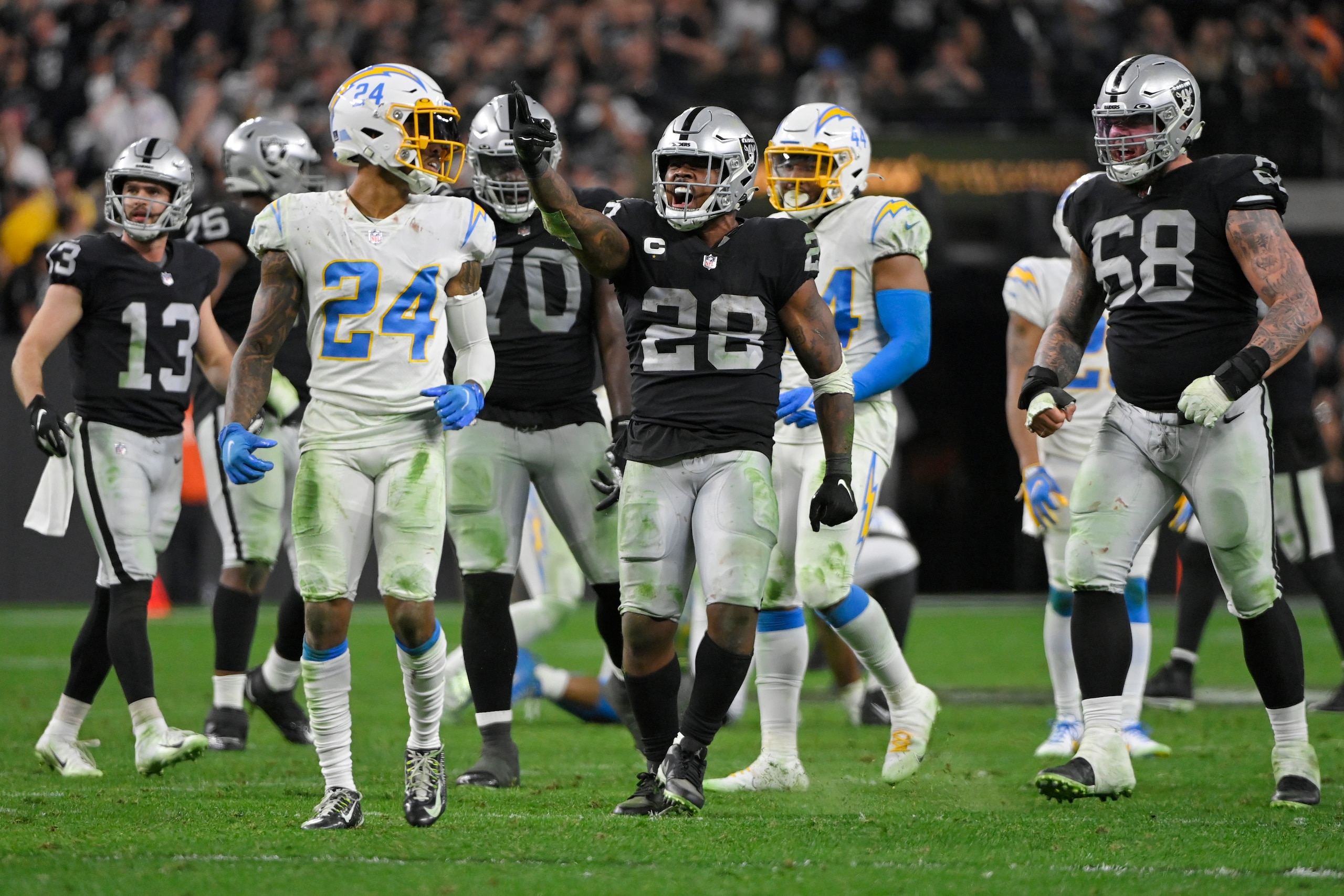 Las Vegas Raiders running back Josh Jacobs (28) celebrates after a play against the Los Angeles Chargers during overtime of an NFL football game, Sunday, Jan. 9, 2022, in Las Vegas. (AP Photo/David Becker) Las Vegas Raiders running back Josh Jacobs (28) celebrates after a play against the Los Angeles Chargers during overtime of an NFL football game, Sunday, Jan. 9, 2022, in Las Vegas. (AP Photo/David Becker)