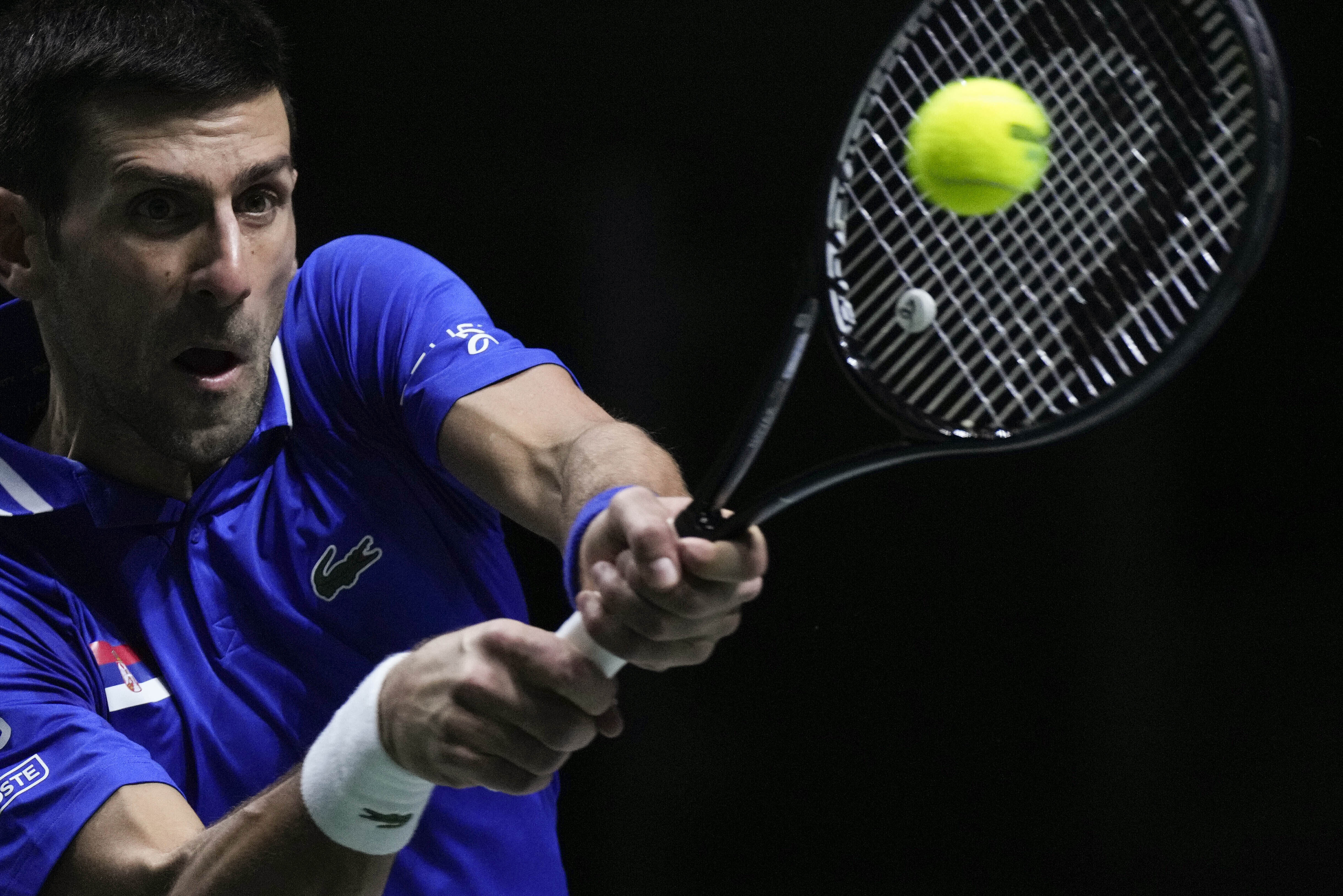 FILE - Serbia's Novak Djokovic returns the ball to Croatia's Marin Cilic during their Davis Cup tennis semi-final match at Madrid Arena in Madrid, Spain, Friday, Dec. 3, 2021. An Australian judge reinstated tennis star Novak Djokovic's visa Monday, Jan. 10, 2022, which was canceled last week because he is unvaccinated. (AP Photo/Bernat Armangue, File)