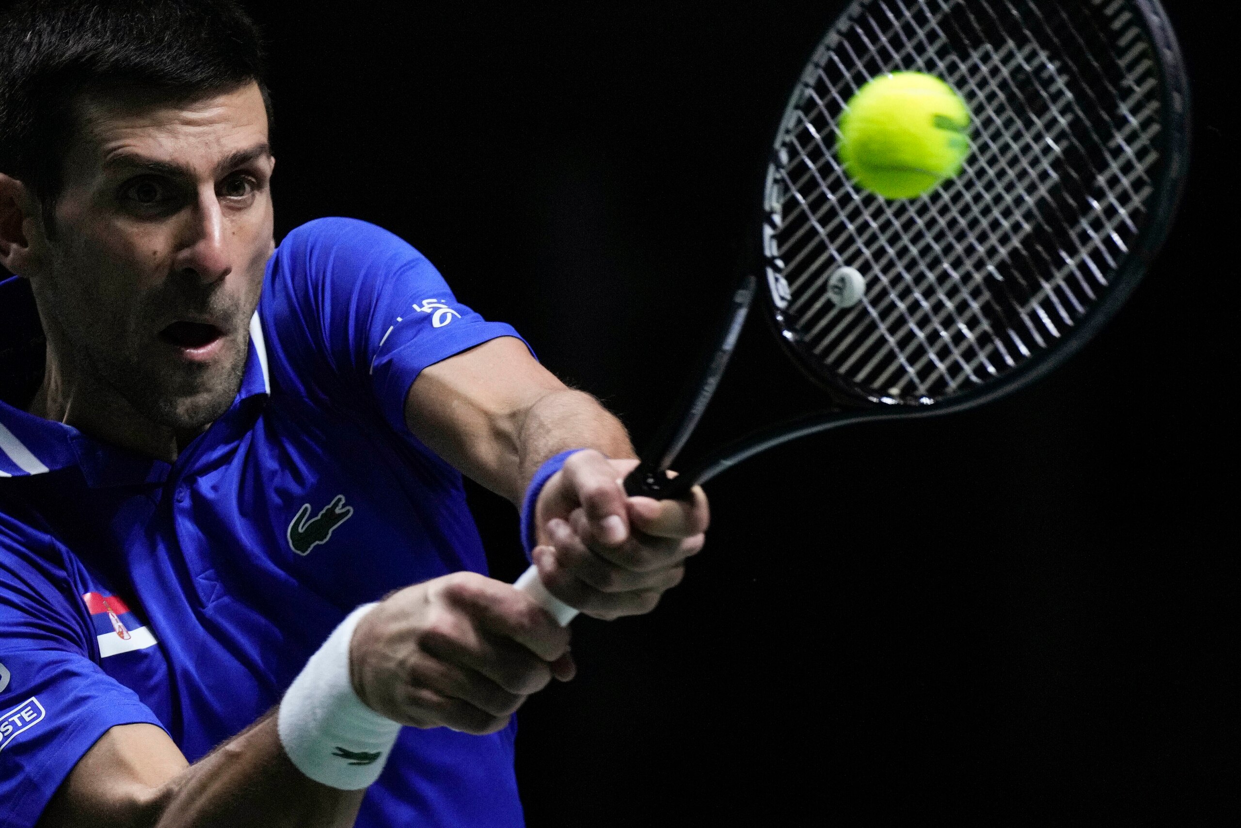 FILE - Serbia's Novak Djokovic returns the ball to Croatia's Marin Cilic during their Davis Cup tennis semi-final match at Madrid Arena in Madrid, Spain, Friday, Dec. 3, 2021. An Australian judge reinstated tennis star Novak Djokovic's visa Monday, Jan. 10, 2022, which was canceled last week because he is unvaccinated. (AP Photo/Bernat Armangue, File)