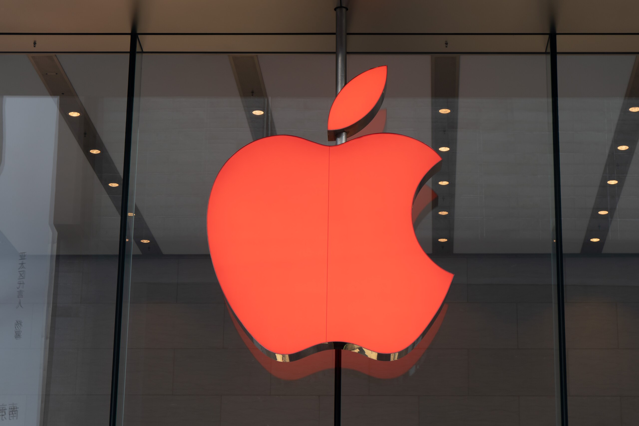 SHANGHAI, CHINA - NOVEMBER 30: The logo of an Apple store turns red for the World AIDS Day on November 30, 2021 in Shanghai, China. World AIDS Day falls on December 1 every year. (Photo by Wang Gang/VCG via Getty Images)