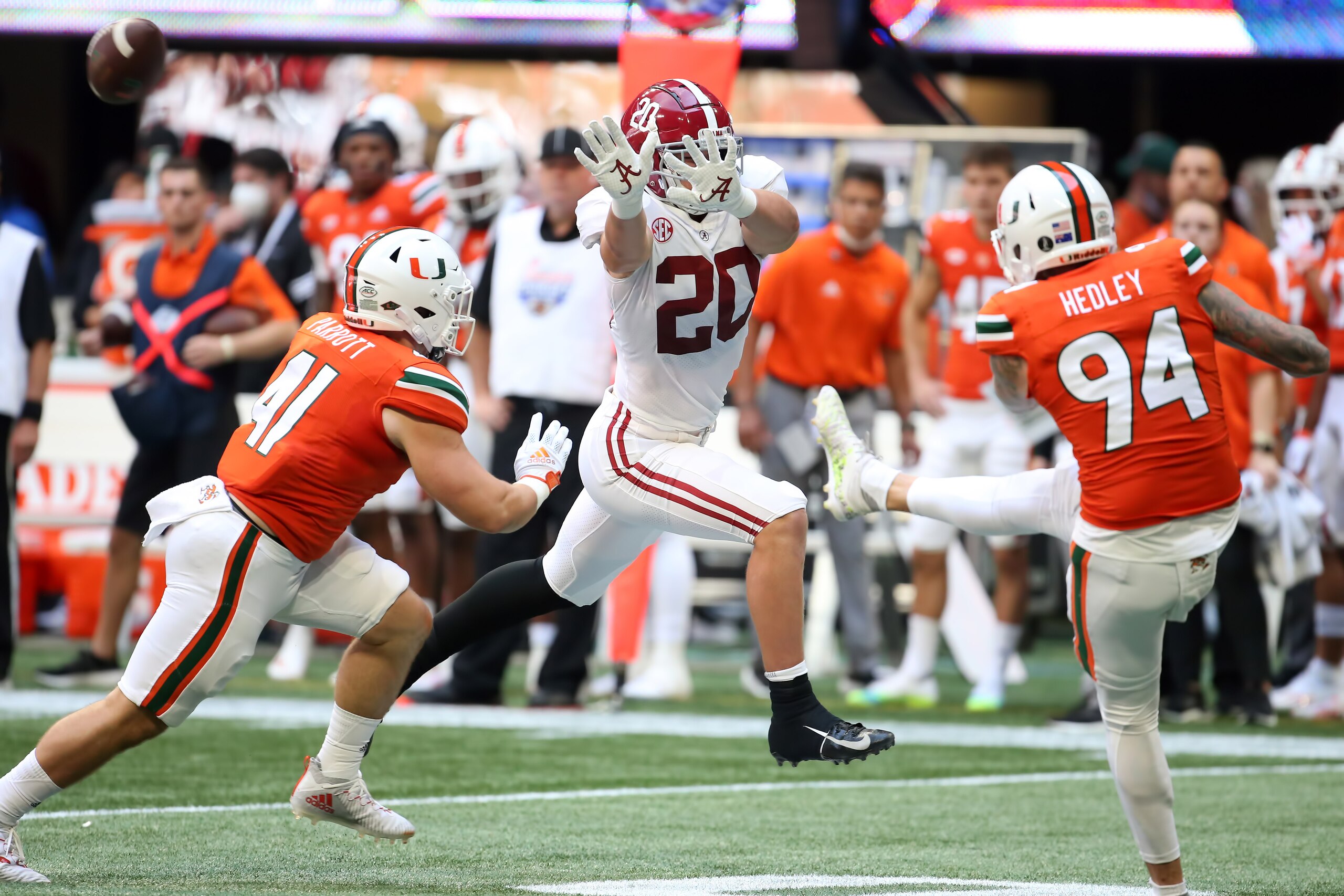 ATLANTA, GA - SEPTEMBER 04: Alabama Crimson Tide linebacker Drew Sanders (20) applies pressure to the Miami Hurricanes punter Lou Hedley (94) during the Chick-fil-A Kickoff Game between the Miami Hurricanes and the Alabama Crimson Tide on September 4, 2021 at Mercedes Benz Stadium in Atlanta, Georgia.  (Photo by Michael Wade/Icon Sportswire via Getty Images)