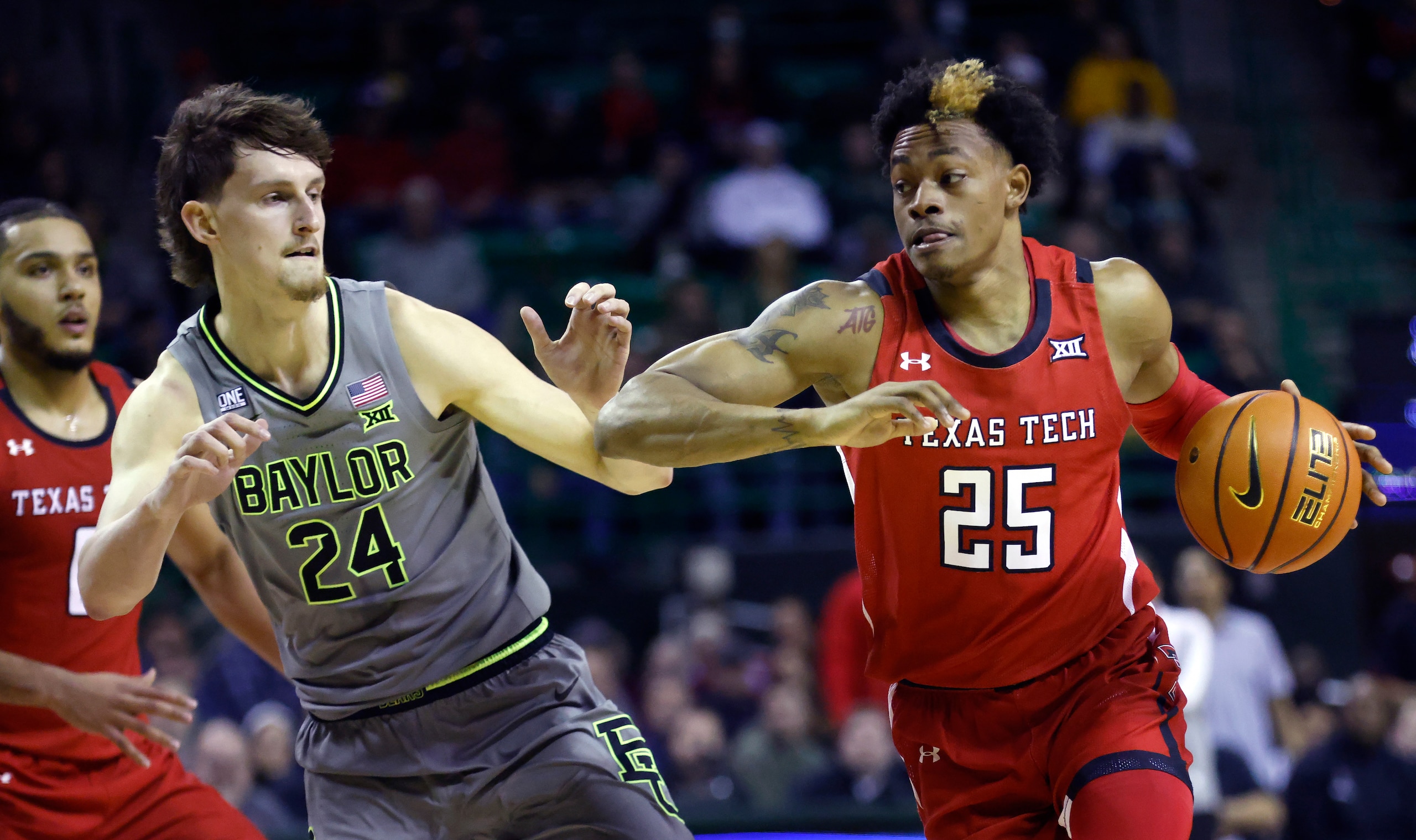 WACO, TX - JANUARY 11: Adonis Arms #25 of the Texas Tech Red Raiders drives inside as Matthew Mayer #24 of the Baylor Bears moves to defend in the first half at the Ferrell Center on January 11, 2022 in Waco, Texas.  (Photo by Ron Jenkins/Getty Images)