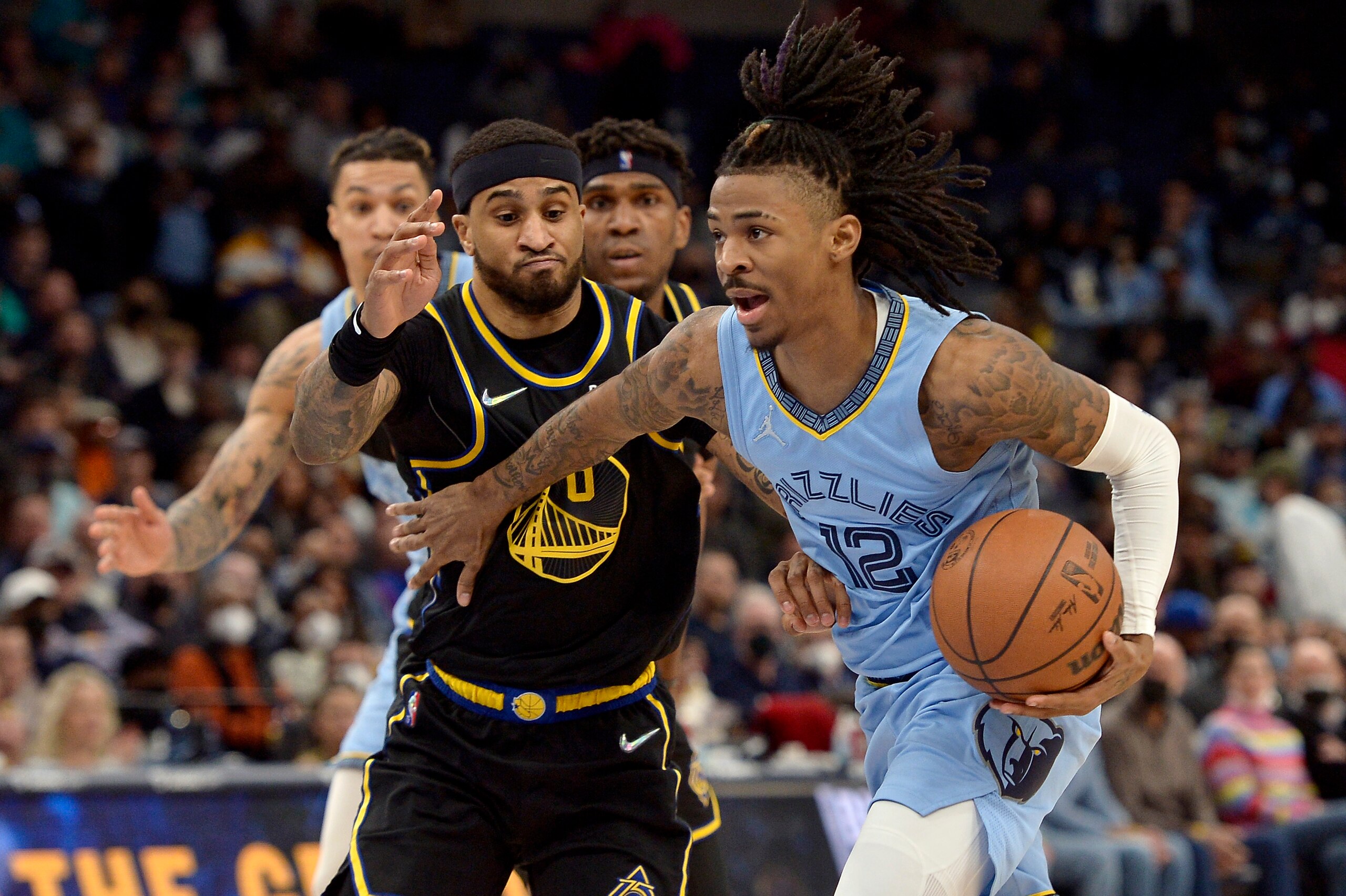Memphis Grizzlies guard Ja Morant (12) handles the ball against Golden State Warriors guard Gary Payton II (0) in the second half of an NBA basketball game Tuesday, Jan. 11, 2022, in Memphis, Tenn. (AP Photo/Brandon Dill) Memphis Grizzlies guard Ja Morant (12) handles the ball against Golden State Warriors guard Gary Payton II (0) in the second half of an NBA basketball game Tuesday, Jan. 11, 2022, in Memphis, Tenn. (AP Photo/Brandon Dill)