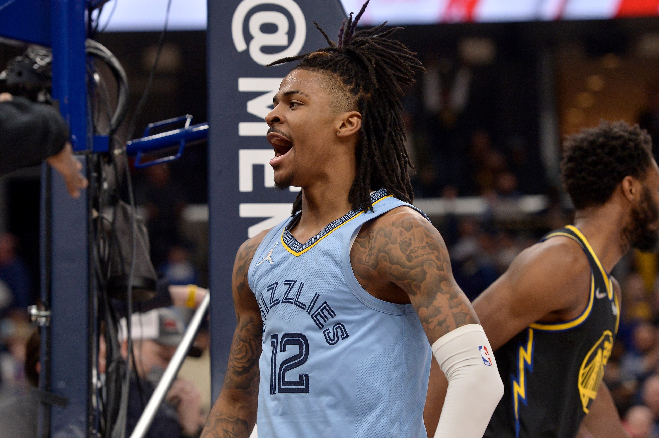 Memphis Grizzlies guard Ja Morant (12) reacts after scoring against the Golden State Warriors in the second half of an NBA basketball game Tuesday, Jan. 11, 2022, in Memphis, Tenn. (AP Photo/Brandon Dill)