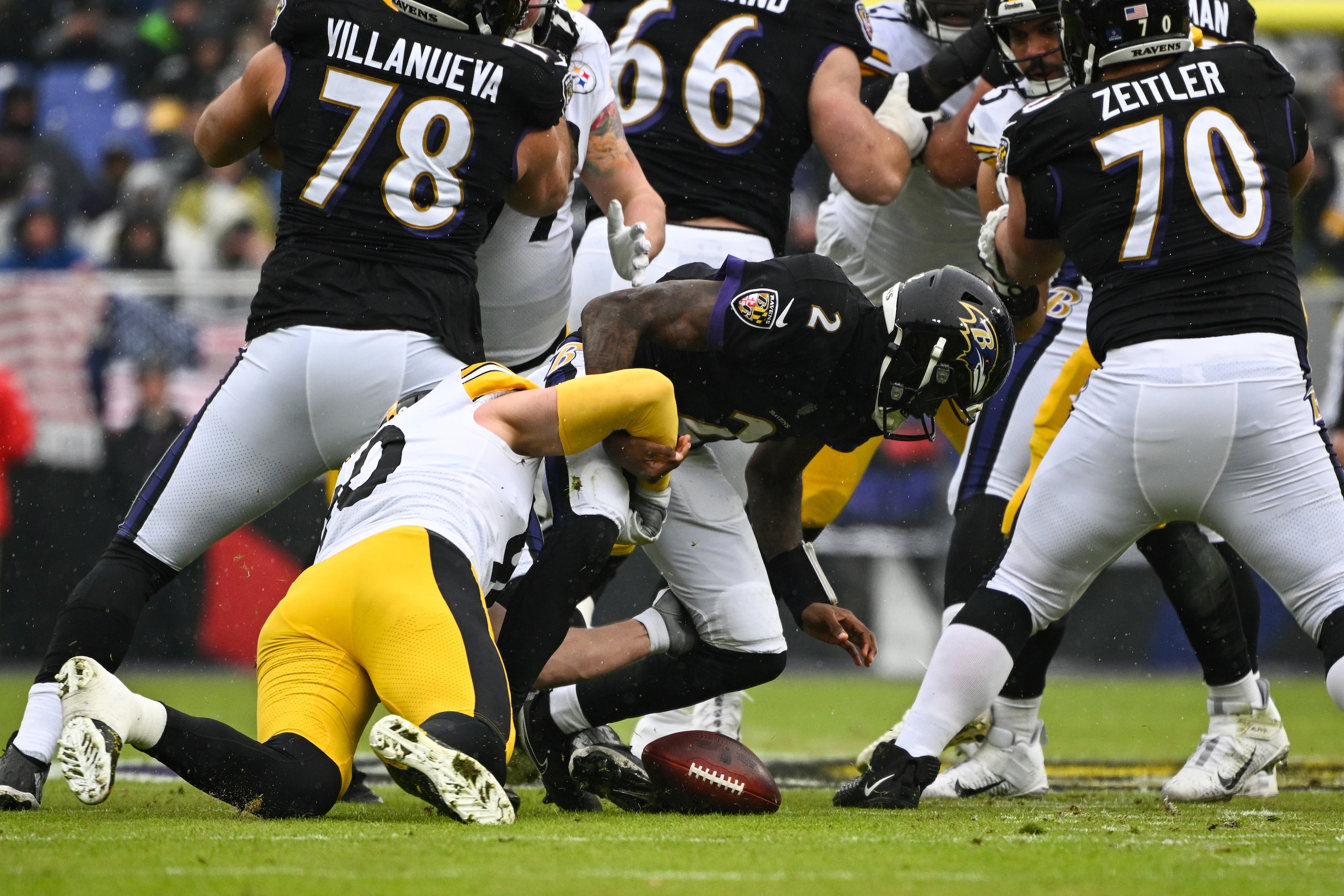 Pittsburgh Steelers outside linebacker T.J. Watt sacks Baltimore Ravens quarterback Tyler Huntley (2) and forces a fumble during the first quarter of an NFL football game, Sunday, Jan. 9, 2022, in Baltimore. (AP Photo/Terrance Williams)