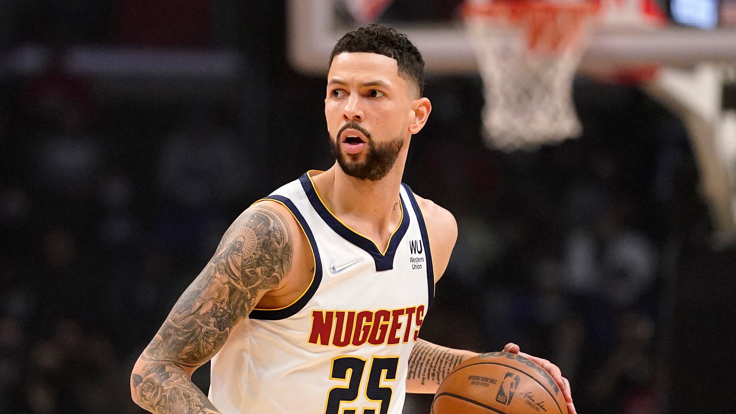 Denver Nuggets guard Austin Rivers dribbles during the first half of an NBA basketball game against the Los Angeles Clippers Tuesday, Jan. 11, 2022, in Los Angeles. (AP Photo/Mark J. Terrill)