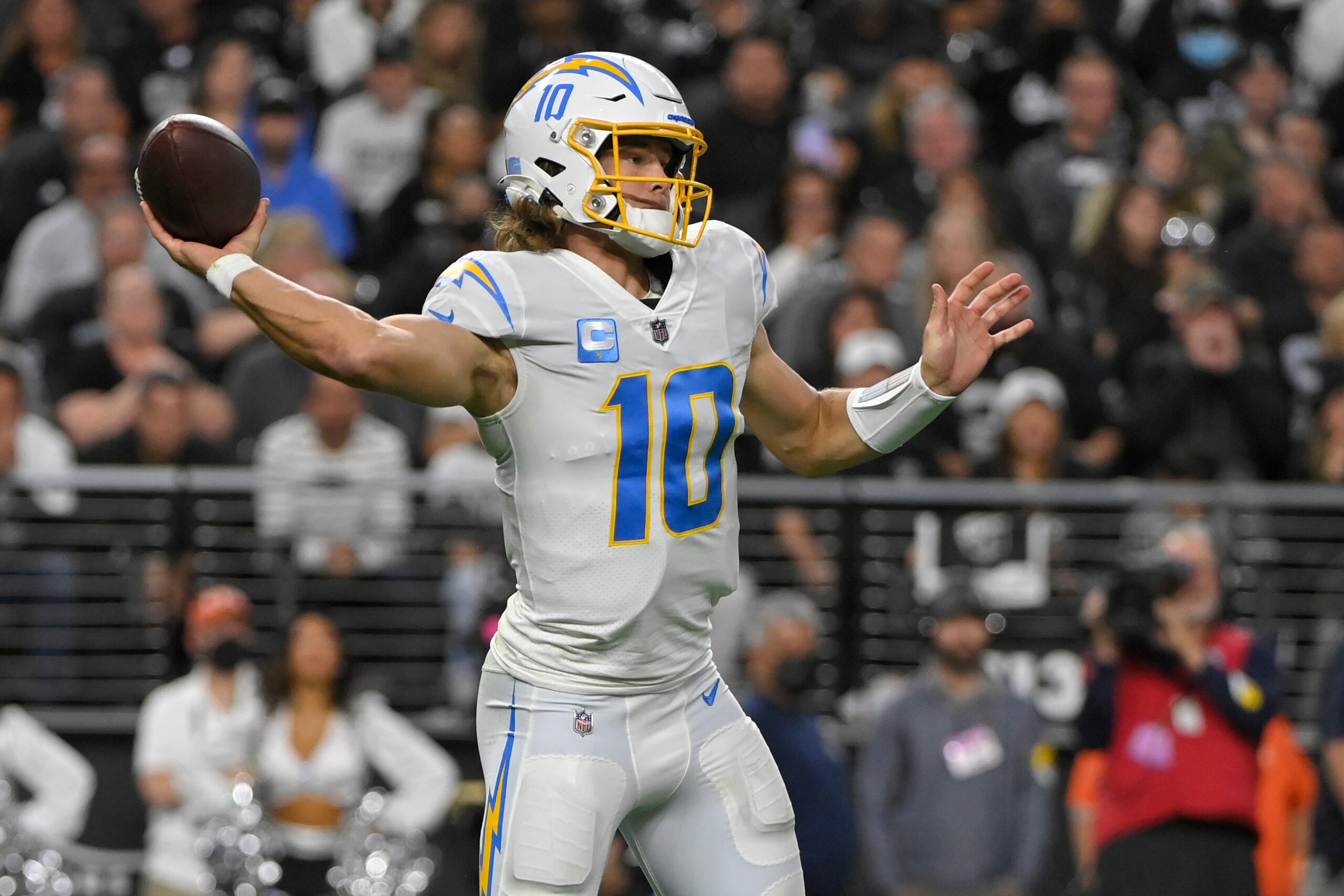 Los Angeles Chargers quarterback Justin Herbert (10) looks to pass against the Las Vegas Raiders during the first half of an NFL football game, Sunday, Jan. 9, 2022, in Las Vegas. (AP Photo/David Becker)