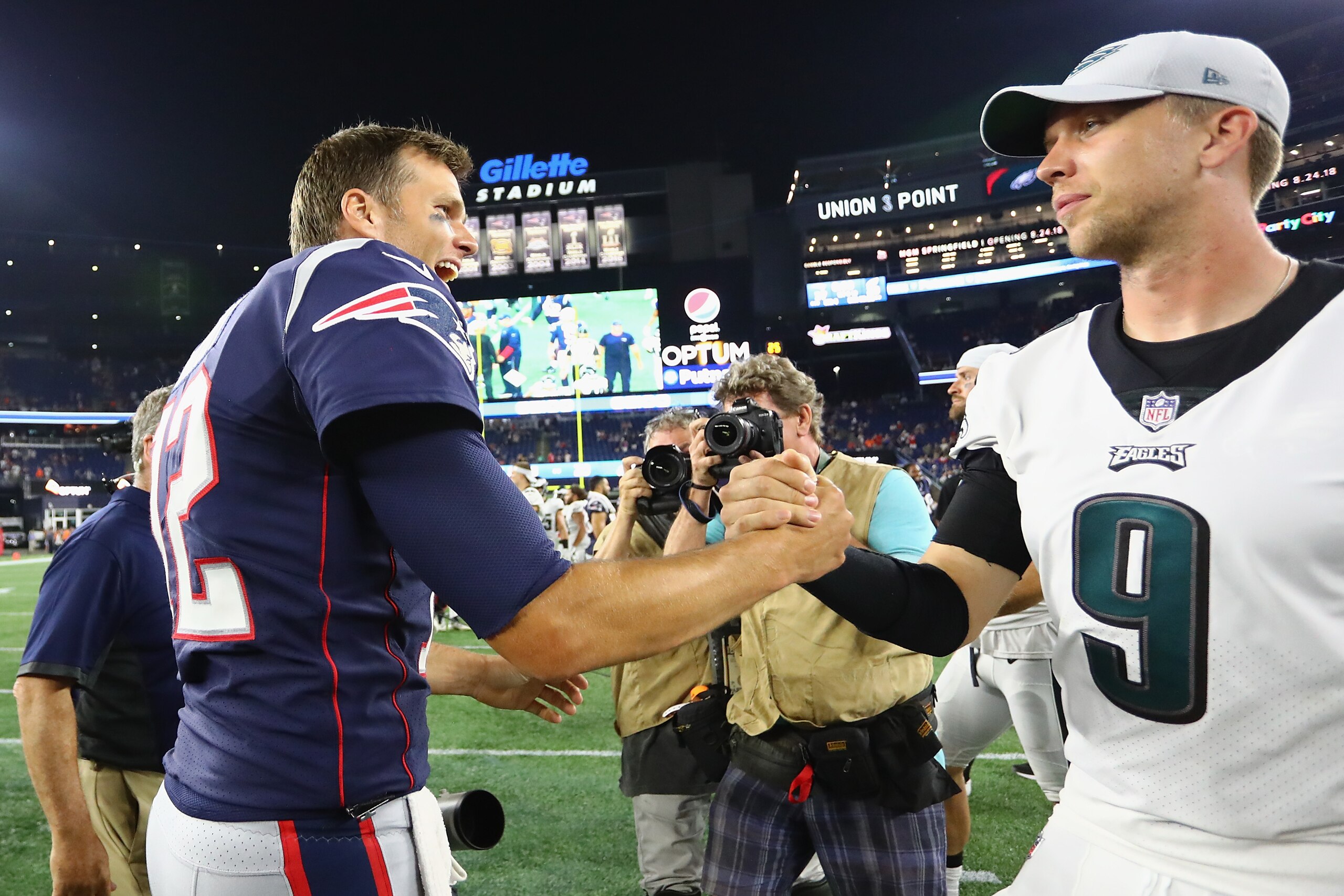 FOXBOROUGH, MA - AUGUST 16:  Tom Brady #12 of the New England Patriots shakes hands with Nick Foles #9 of the Philadelphia Eagles after the Patriots defeated the Eagles 37-20 in a preseason game at Gillette Stadium on August 16, 2018 in Foxborough, Massachusetts.  (Photo by Tim Bradbury/Getty Images)