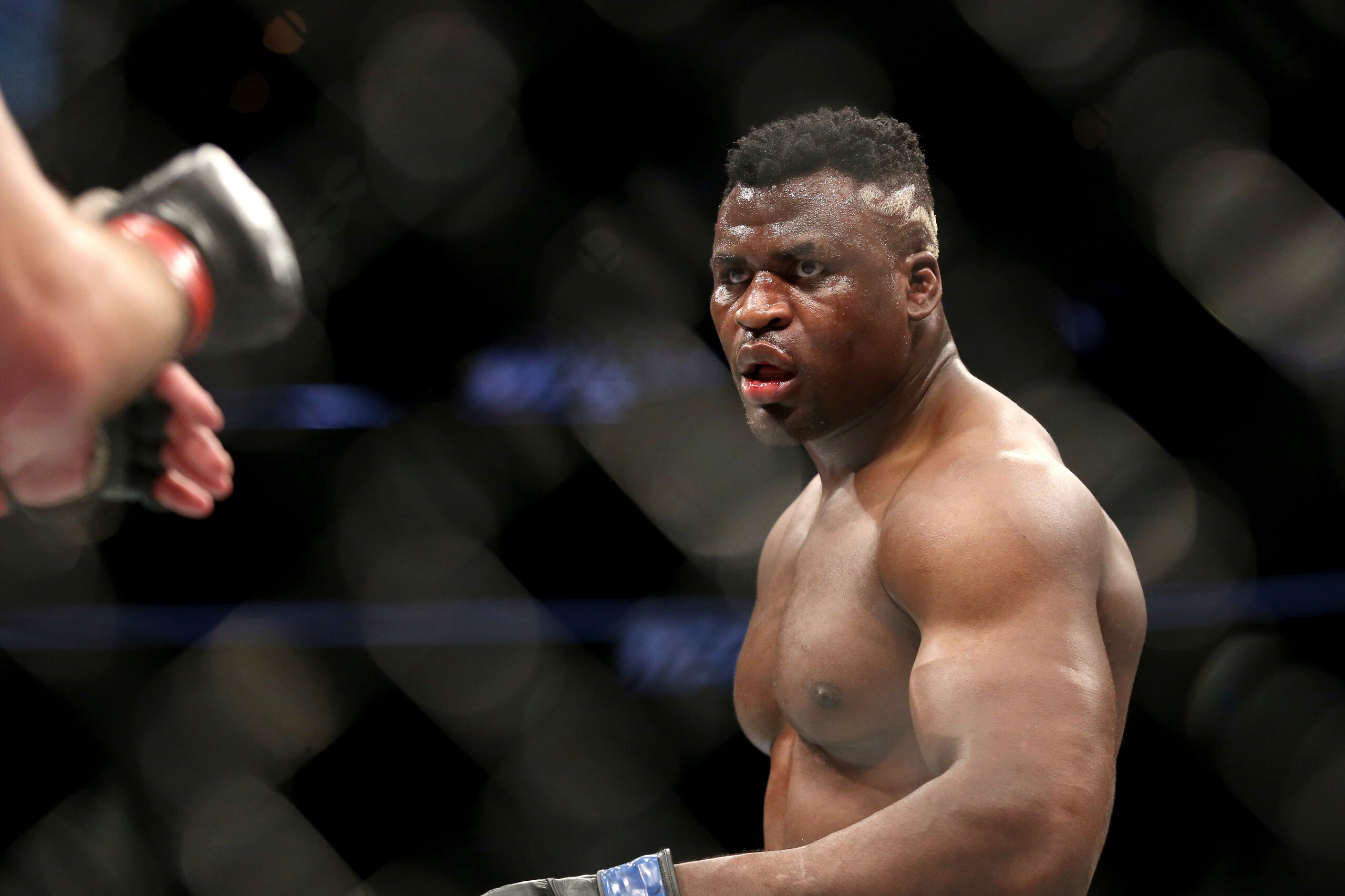 Francis Ngannou in action against Stipe Miocic during a heavyweight championship mixed martial arts bout at UFC 220, Sunday, Jan. 21, 2018, in Boston. Miocic retained his title via unanimous decision. (AP Photo/Gregory Payan)