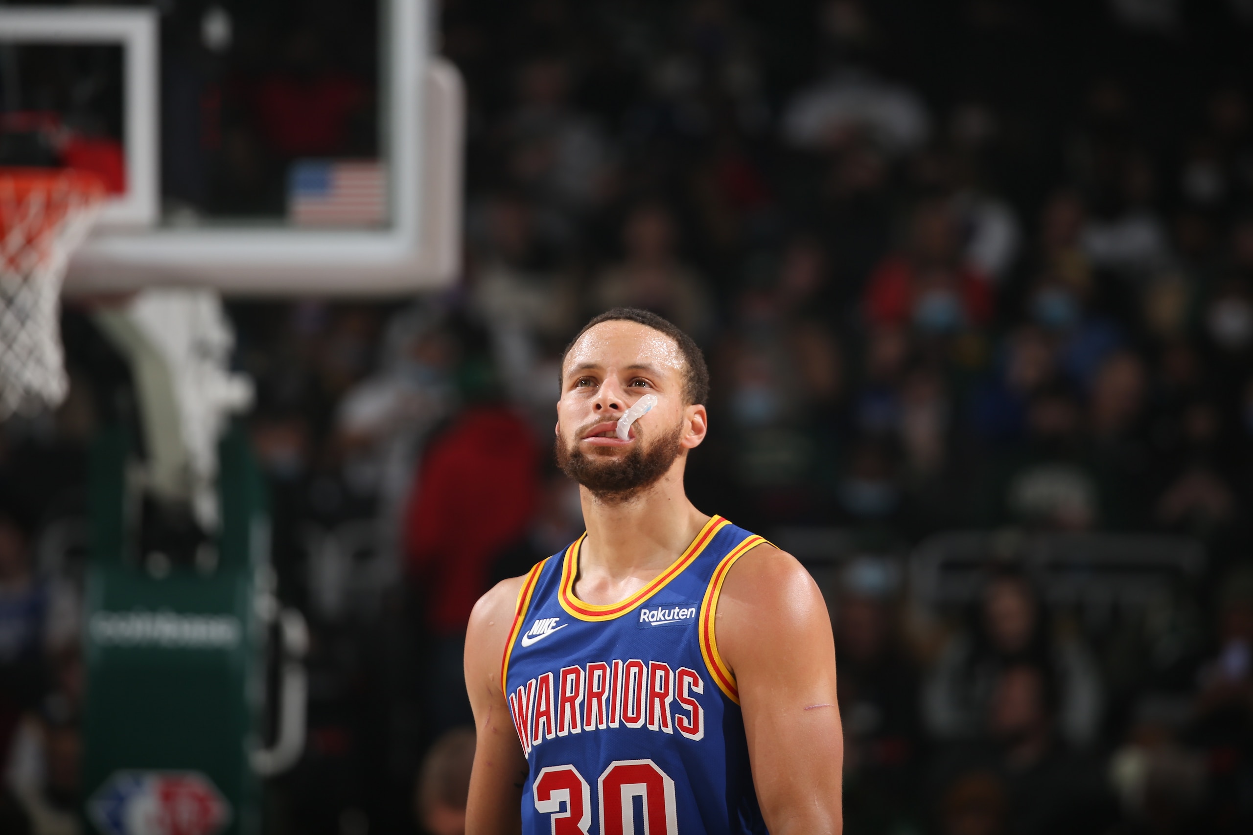 MILWAUKEE, WI - JANUARY 13: Stephen Curry #30 of the Golden State Warriors looks on during the game against the Milwaukee Bucks on January 13, 2022 at the Fiserv Forum Center in Milwaukee, Wisconsin. NOTE TO USER: User expressly acknowledges and agrees that, by downloading and or using this Photograph, user is consenting to the terms and conditions of the Getty Images License Agreement. Mandatory Copyright Notice: Copyright 2022 NBAE (Photo by Gary Dineen/NBAE via Getty Images).