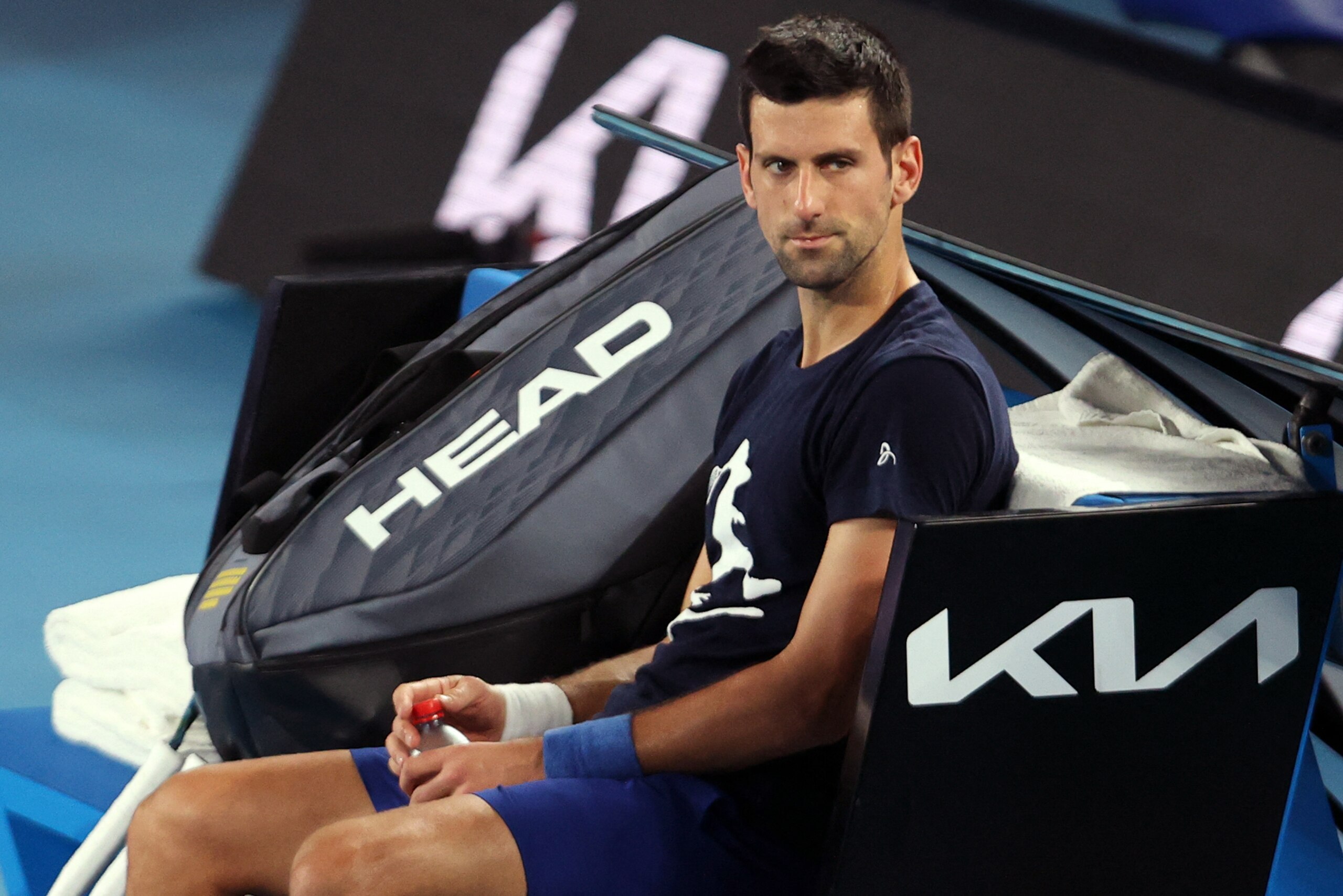 TOPSHOT - Novak Djokovic of Serbia attends a practice session ahead of the Australian Open tennis tournament in Melbourne on January 14, 2022. - --IMAGE RESTRICTED TO EDITORIAL USE - NO COMMERCIAL USE-- (Photo by MARTIN KEEP / AFP) / --IMAGE RESTRICTED TO EDITORIAL USE - NO COMMERCIAL USE-- (Photo by MARTIN KEEP/AFP via Getty Images)