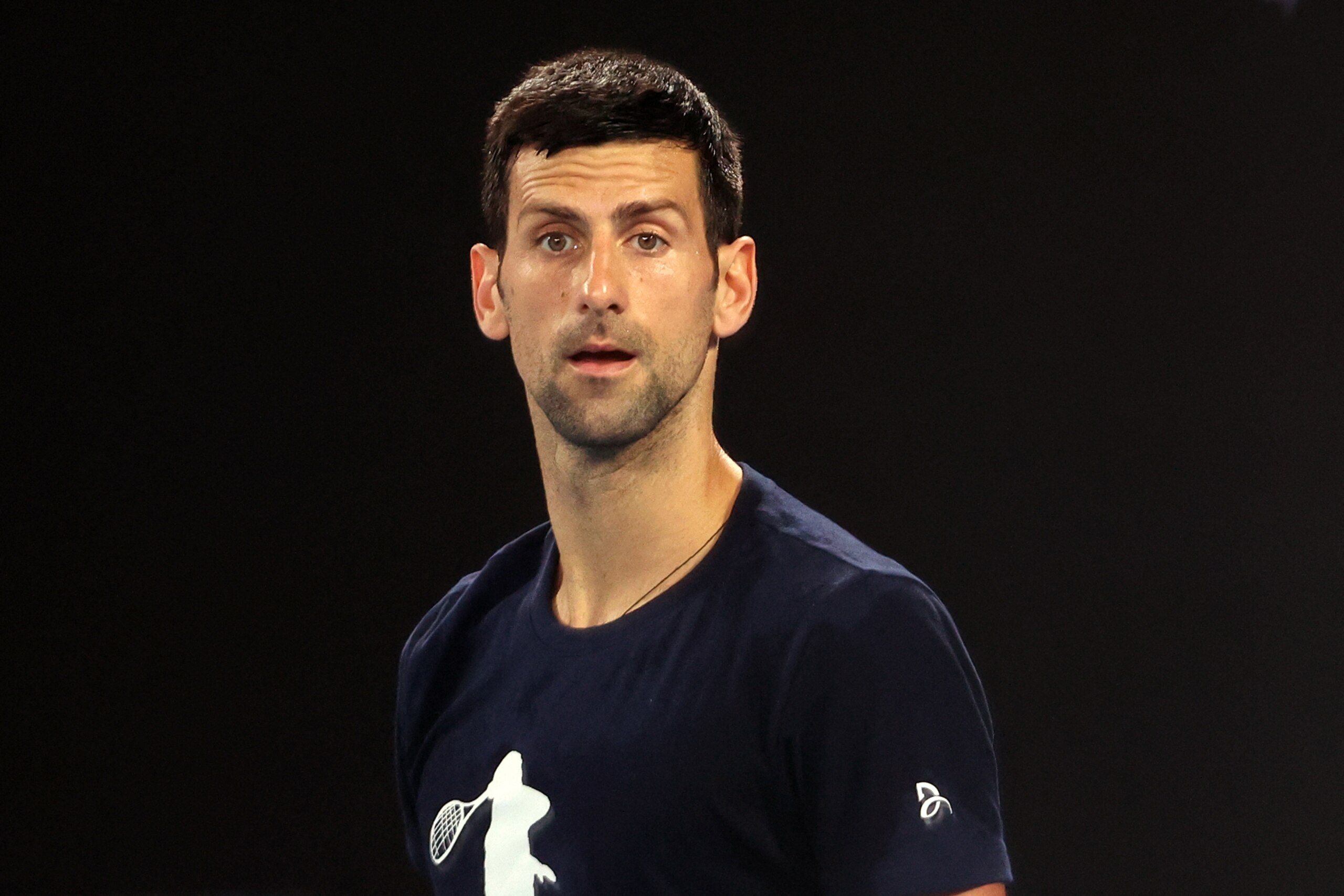 Novak Djokovic of Serbia attends a practice session ahead of the Australian Open tennis tournament in Melbourne on January 14, 2022. - --IMAGE RESTRICTED TO EDITORIAL USE - NO COMMERCIAL USE-- (Photo by MARTIN KEEP / AFP) / --IMAGE RESTRICTED TO EDITORIAL USE - NO COMMERCIAL USE-- (Photo by MARTIN KEEP/AFP via Getty Images)
