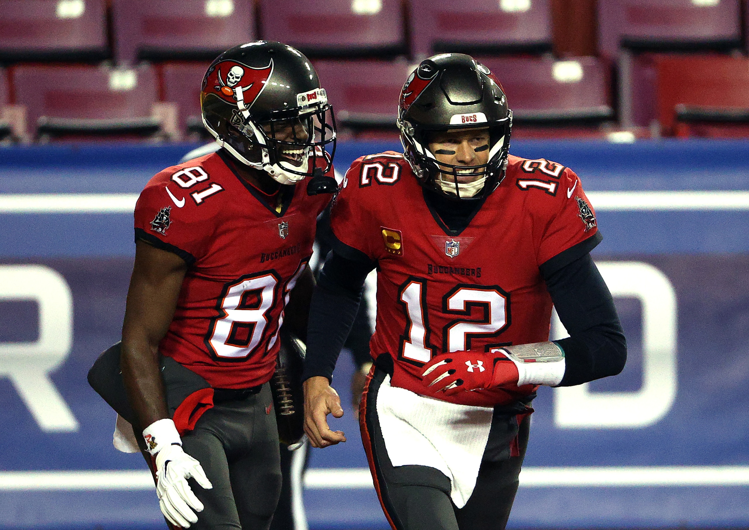 LANDOVER, MARYLAND - JANUARY 09: Quarterback Tom Brady #12 of the Tampa Bay Buccaneers congratulates wide receiver Antonio Brown #81 after a touchdown during the 1st quarter of the game against the Washington Football Team at FedExField on January 09, 2021 in Landover, Maryland. (Photo by Patrick Smith/Getty Images) LANDOVER, MARYLAND - JANUARY 09: Quarterback Tom Brady #12 of the Tampa Bay Buccaneers congratulates wide receiver Antonio Brown #81 after a touchdown during the 1st quarter of the game against the Washington Football Team at FedExField on January 09, 2021 in Landover, Maryland. (Photo by Patrick Smith/Getty Images)