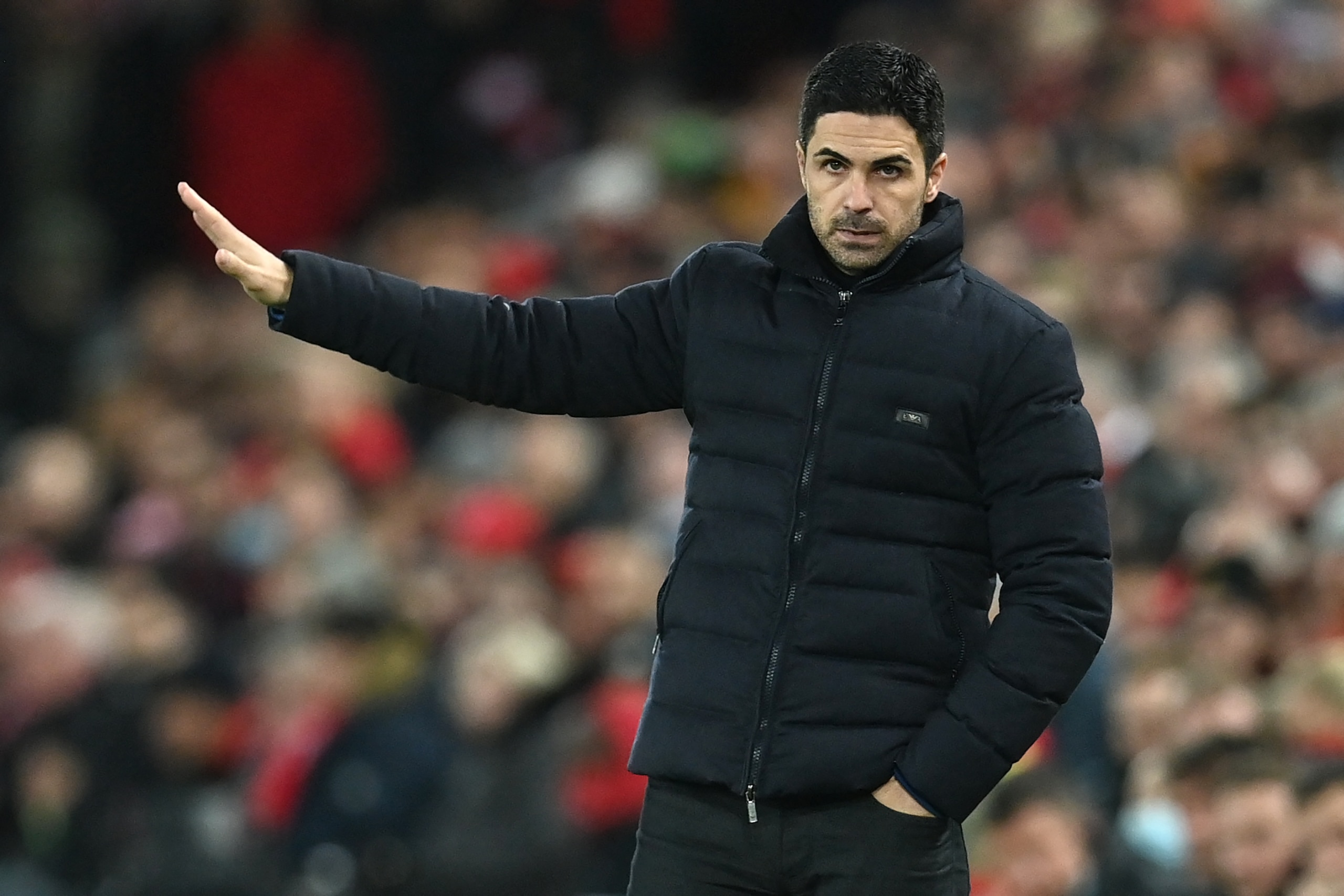 Arsenal's Spanish manager Mikel Arteta gestures on the touchline during the English League Cup semi-final first leg football match between Liverpool and Arsenal at Anfield in Liverpool, north west England on January 13, 2022. - - RESTRICTED TO EDITORIAL USE. No use with unauthorized audio, video, data, fixture lists, club/league logos or 'live' services. Online in-match use limited to 120 images. An additional 40 images may be used in extra time. No video emulation. Social media in-match use limited to 120 images. An additional 40 images may be used in extra time. No use in betting publications, games or single club/league/player publications. (Photo by Paul ELLIS / AFP) / RESTRICTED TO EDITORIAL USE. No use with unauthorized audio, video, data, fixture lists, club/league logos or 'live' services. Online in-match use limited to 120 images. An additional 40 images may be used in extra time. No video emulation. Social media in-match use limited to 120 images. An additional 40 images may be used in extra time. No use in betting publications, games or single club/league/player publications. / RESTRICTED TO EDITORIAL USE. No use with unauthorized audio, video, data, fixture lists, club/league logos or 'live' services. Online in-match use limited to 120 images. An additional 40 images may be used in extra time. No video emulation. Social media in-match use limited to 120 images. An additional 40 images may be used in extra time. No use in betting publications, games or single club/league/player publications. (Photo by PAUL ELLIS/AFP via Getty Images)