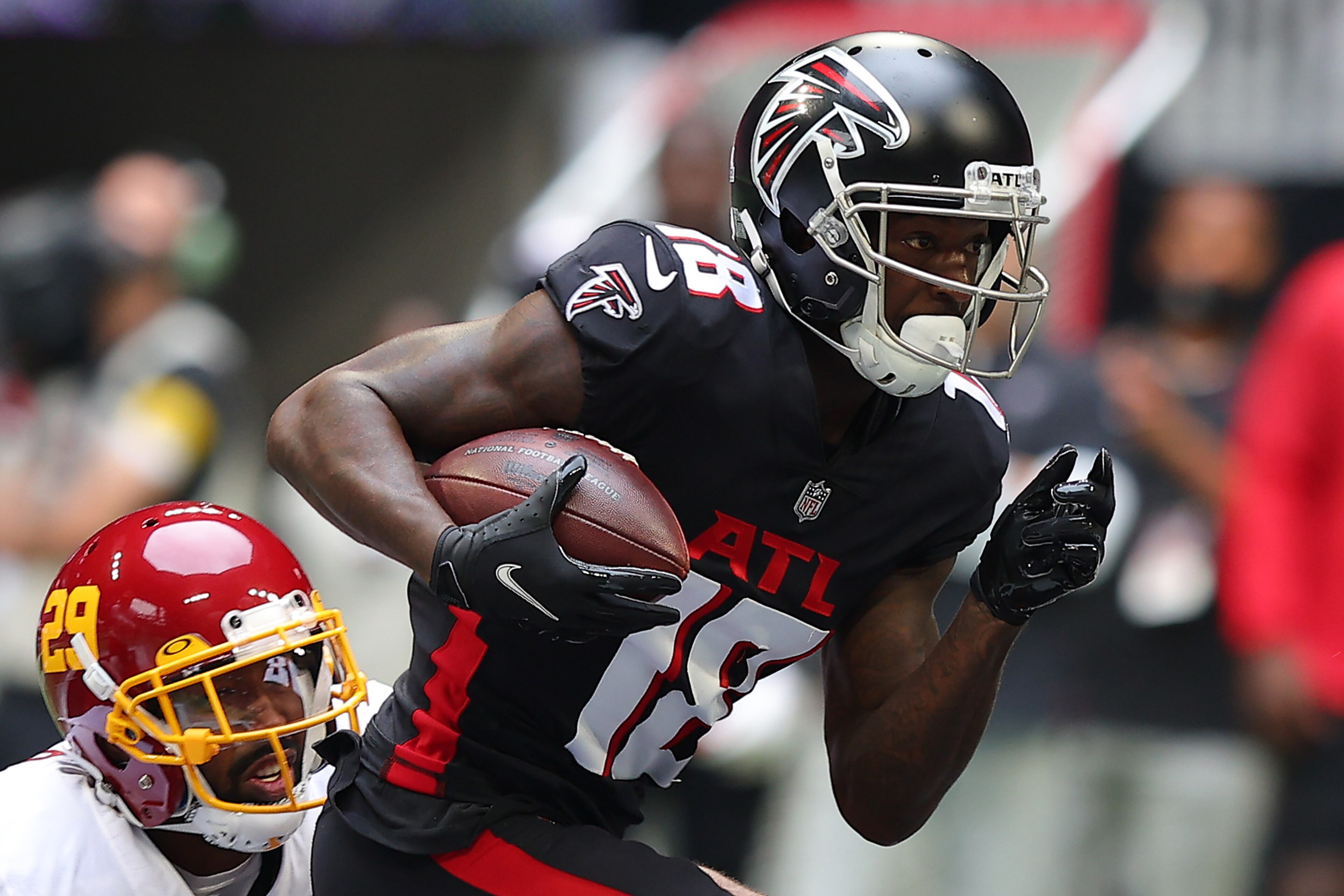ATLANTA, GEORGIA - OCTOBER 03: Calvin Ridley #18 of the Atlanta Falcons runs with the ball after the catch against Kendall Fuller #29 of the Washington Football Team in the first quarter at Mercedes-Benz Stadium on October 03, 2021 in Atlanta, Georgia. (Photo by Kevin C. Cox/Getty Images) ATLANTA, GEORGIA - OCTOBER 03: Calvin Ridley #18 of the Atlanta Falcons runs with the ball after the catch against Kendall Fuller #29 of the Washington Football Team in the first quarter at Mercedes-Benz Stadium on October 03, 2021 in Atlanta, Georgia. (Photo by Kevin C. Cox/Getty Images)