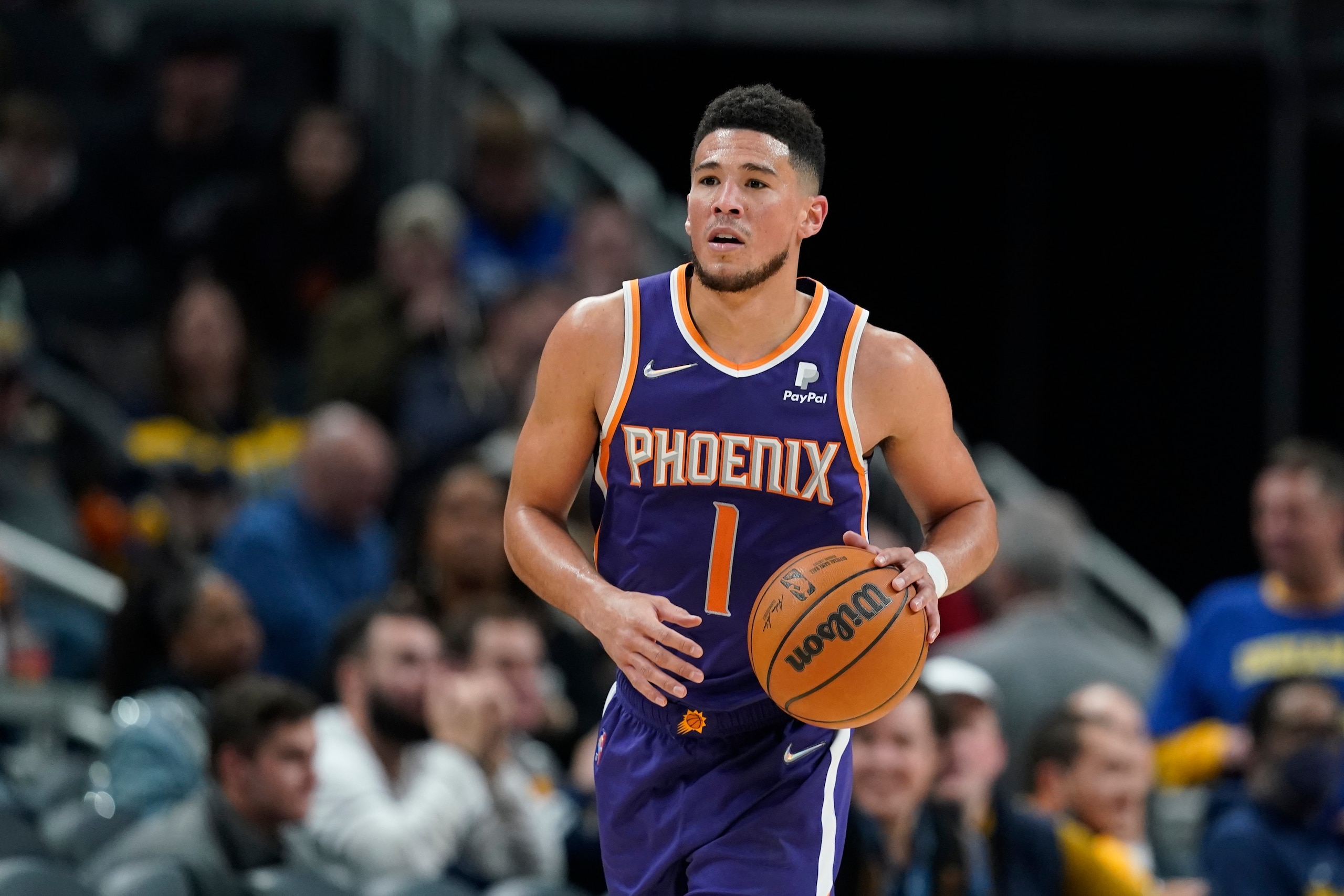 Phoenix Suns' Devin Booker dribbles during the second half of an NBA basketball game against the Indiana Pacers, Friday, Jan. 14, 2022, in Indianapolis. (AP Photo/Darron Cummings)