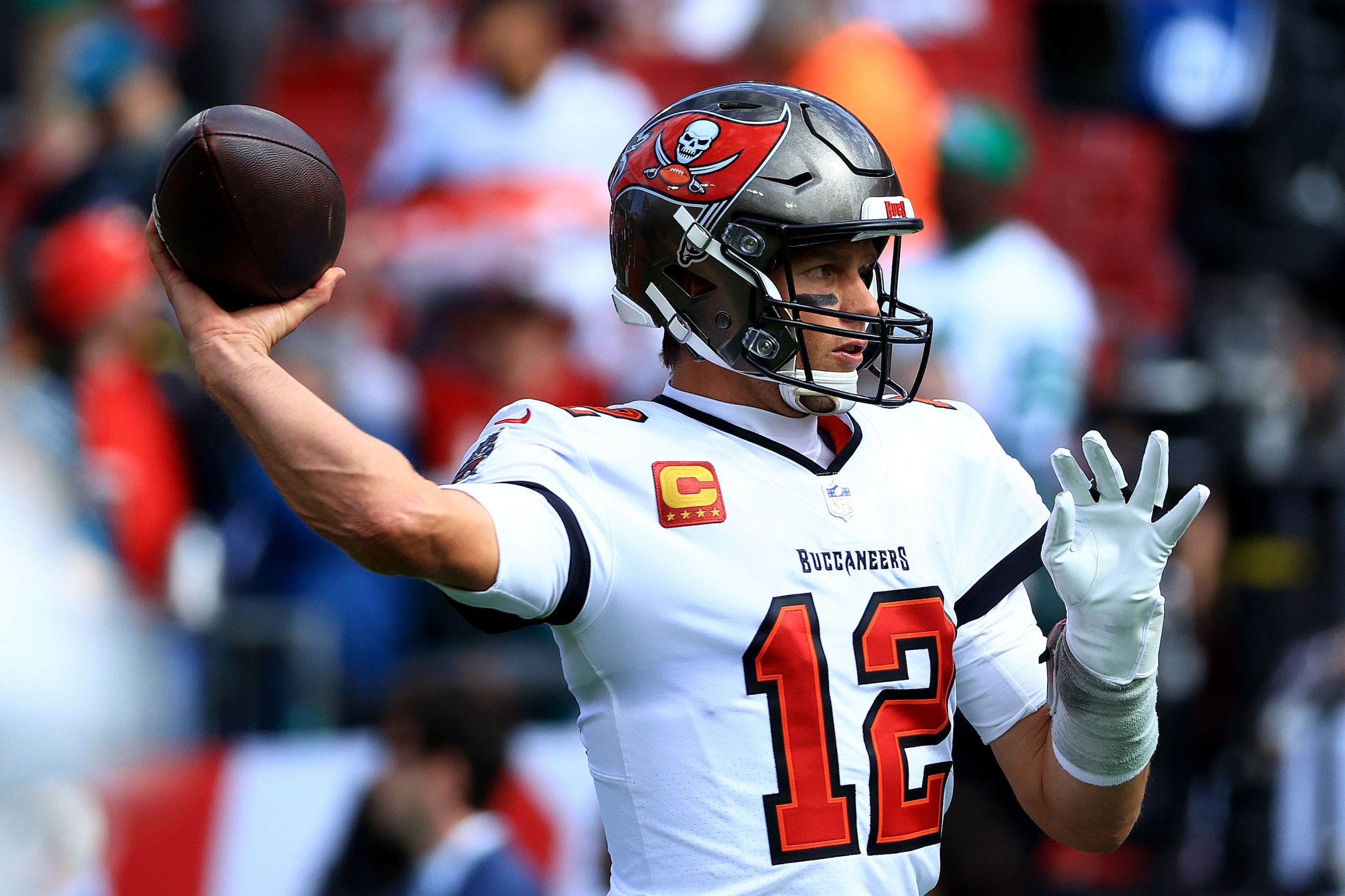 TAMPA, FLORIDA - JANUARY 16: Tom Brady #12 of the Tampa Bay Buccaneers warms up prior to the NFC Wild Card Playoff game against the Philadelphia Eagles at Raymond James Stadium on January 16, 2022 in Tampa, Florida. (Photo by Mike Ehrmann/Getty Images)