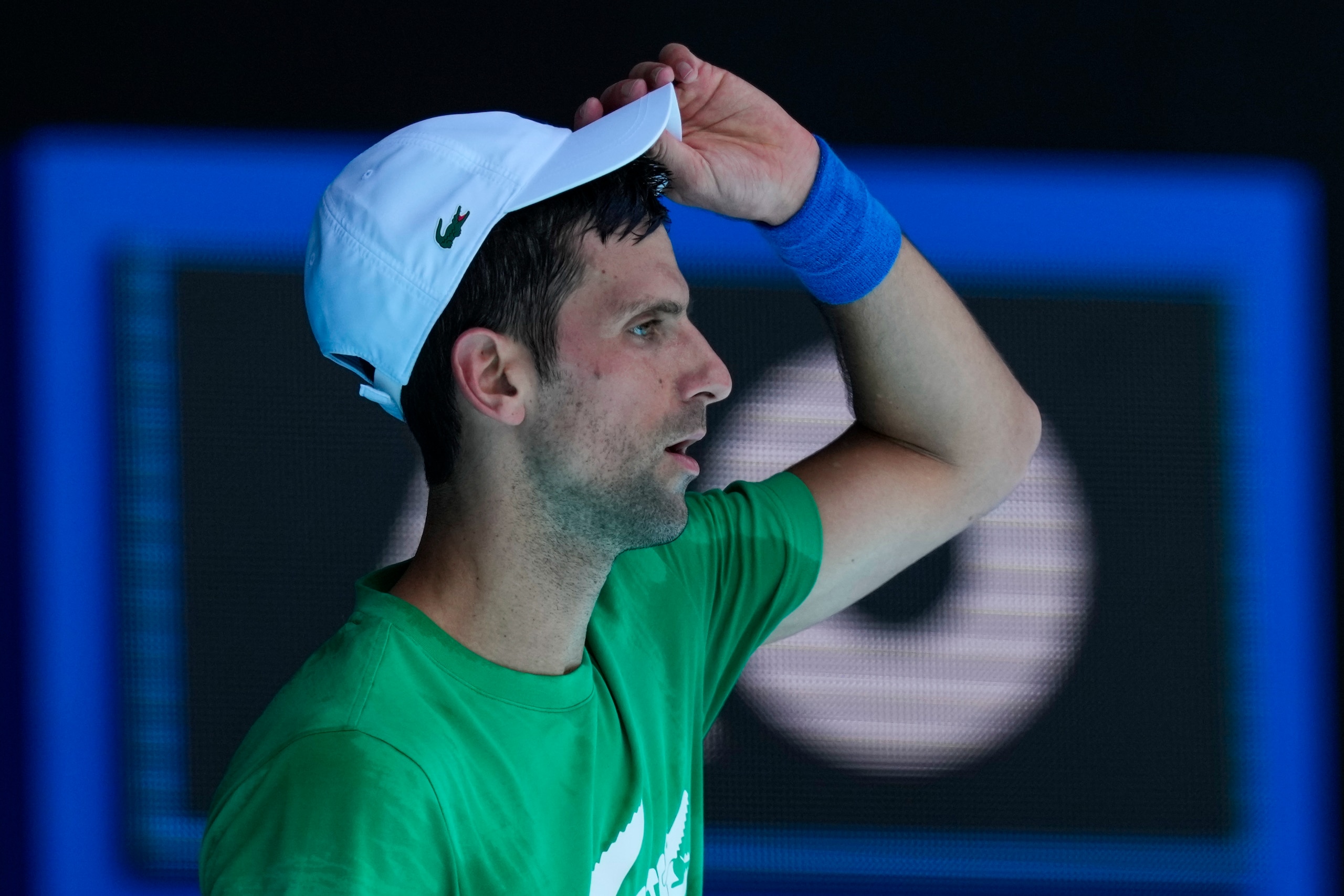 FILE - Defending men's champion Serbia's Novak Djokovic practices on Margaret Court Arena ahead of the Australian Open tennis championship in Melbourne, Australia, Jan. 13, 2022. Djokovic’s effort to play in the Australian Open despite being unvaccinated for COVID-19 moved to a higher court as the No. 1-ranked tennis player appealed the second cancellation of his visa. A judge scheduled another hearing for Sunday, Jan. 16. (AP Photo/Mark Baker, File)