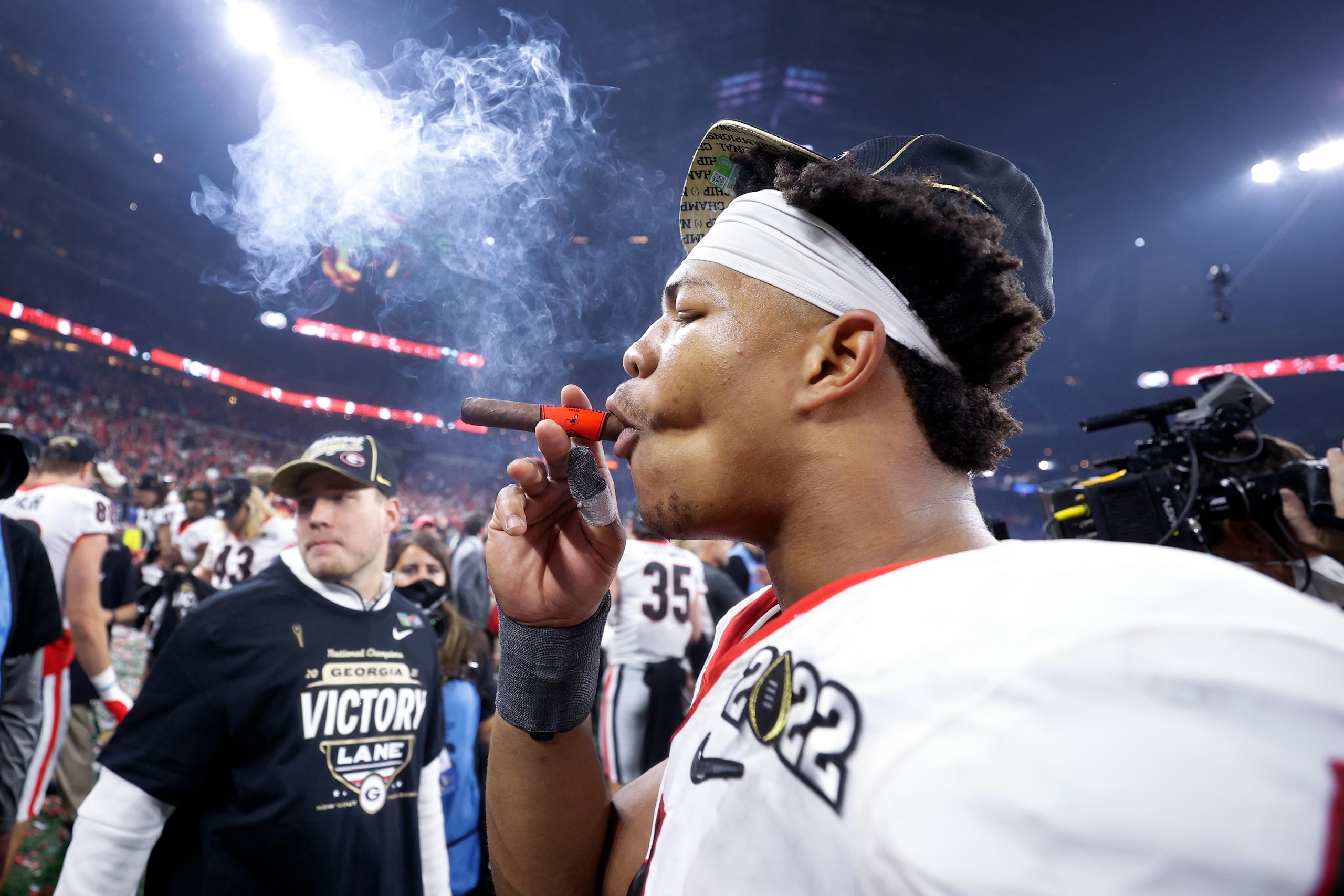 INDIANAPOLIS, IN - JANUARY 10: Georgia Bulldogs linebacker Nolan Smith (4) celebrates with a cigar following the CFP National Championship college football game against the Alabama Crimson Tide on Jan. 10, 2022 at Lucas Oil Stadium in Indianapolis, Indiana. (Photo by Joe Robbins/Icon Sportswire via Getty Images)