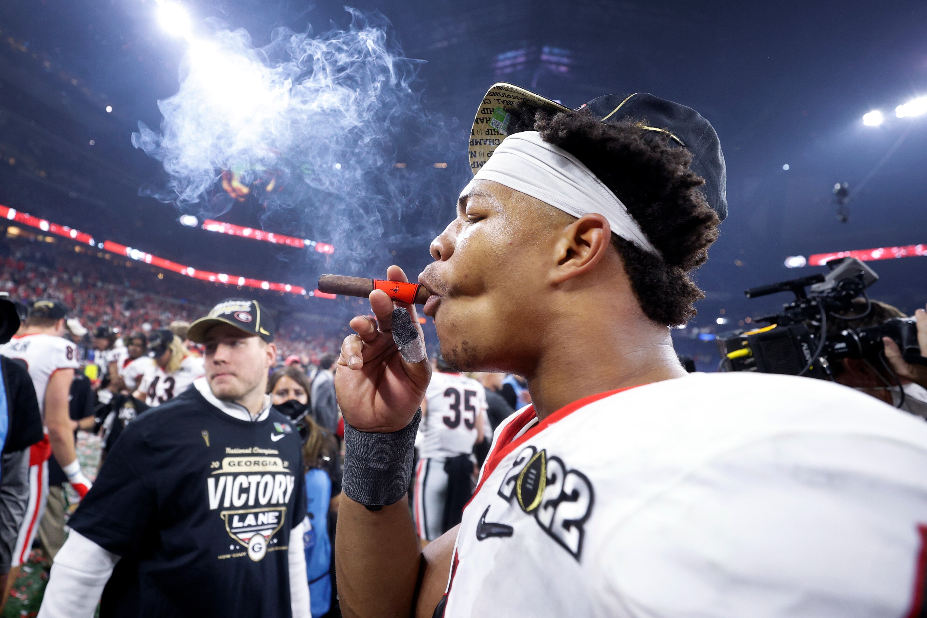 INDIANAPOLIS, IN - JANUARY 10: Georgia Bulldogs linebacker Nolan Smith (4) celebrates with a cigar following the CFP National Championship college football game against the Alabama Crimson Tide on Jan. 10, 2022 at Lucas Oil Stadium in Indianapolis, Indiana. (Photo by Joe Robbins/Icon Sportswire via Getty Images) INDIANAPOLIS, IN - JANUARY 10: Georgia Bulldogs linebacker Nolan Smith (4) celebrates with a cigar following the CFP National Championship college football game against the Alabama Crimson Tide on Jan. 10, 2022 at Lucas Oil Stadium in Indianapolis, Indiana. (Photo by Joe Robbins/Icon Sportswire via Getty Images)