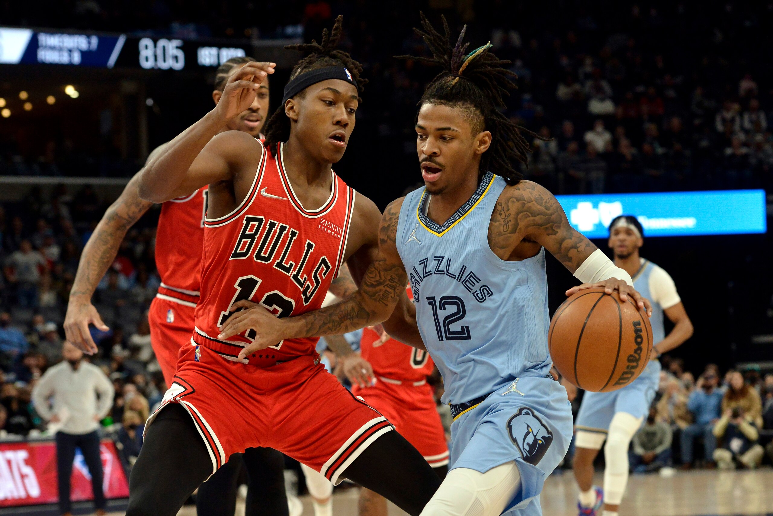 Memphis Grizzlies guard Ja Morant (12) handles the ball against Chicago Bulls guard Ayo Dosunmu (12) in the first half of an NBA basketball game Monday, Jan. 17, 2022, in Memphis, Tenn. (AP Photo/Brandon Dill)