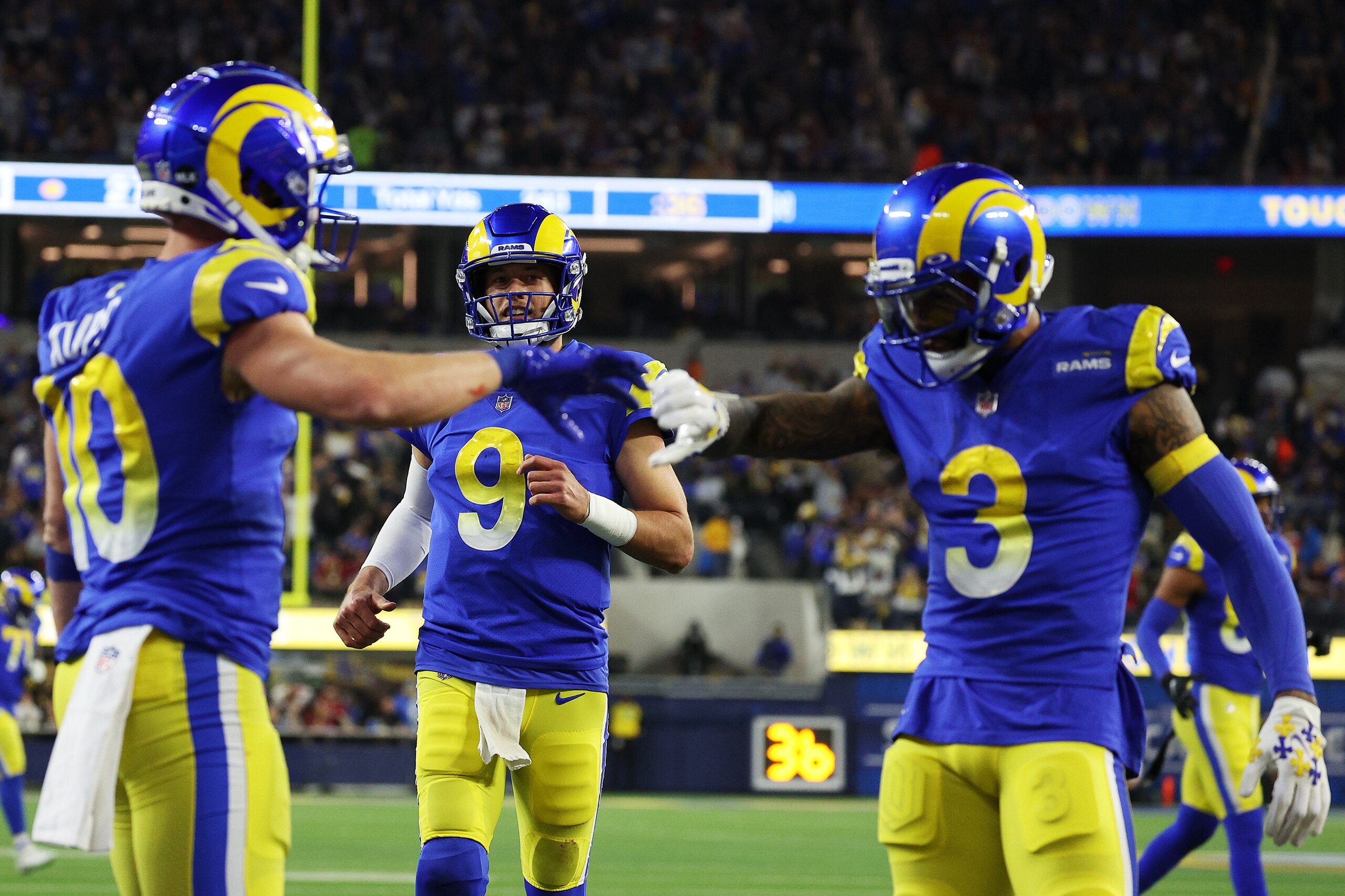 INGLEWOOD, CALIFORNIA - JANUARY 17: (EDITORS NOTE: Retransmission with alternate crop.) Matthew Stafford #9 of the Los Angeles Rams celebrates his touchdown pass to Cooper Kupp #10 of the Los Angeles Rams during the third quarter against the Arizona Cardinals in the NFC Wild Card Playoff game at SoFi Stadium on January 17, 2022 in Inglewood, California. (Photo by Harry How/Getty Images)