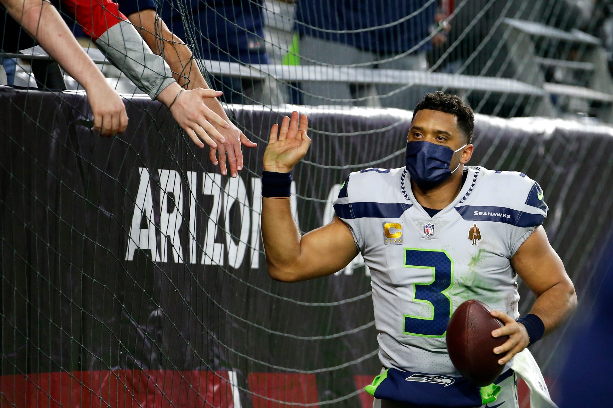 Seattle Seahawks quarterback Russell Wilson gets high-fives from fans after the Seahawks defeated the Arizona Cardinals after an NFL football game Sunday, Jan. 9, 2022, in Glendale, Ariz. The Seahawks won 38-30. (AP Photo/Ralph Freso) Seattle Seahawks quarterback Russell Wilson gets high-fives from fans after the Seahawks defeated the Arizona Cardinals after an NFL football game Sunday, Jan. 9, 2022, in Glendale, Ariz. The Seahawks won 38-30. (AP Photo/Ralph Freso)