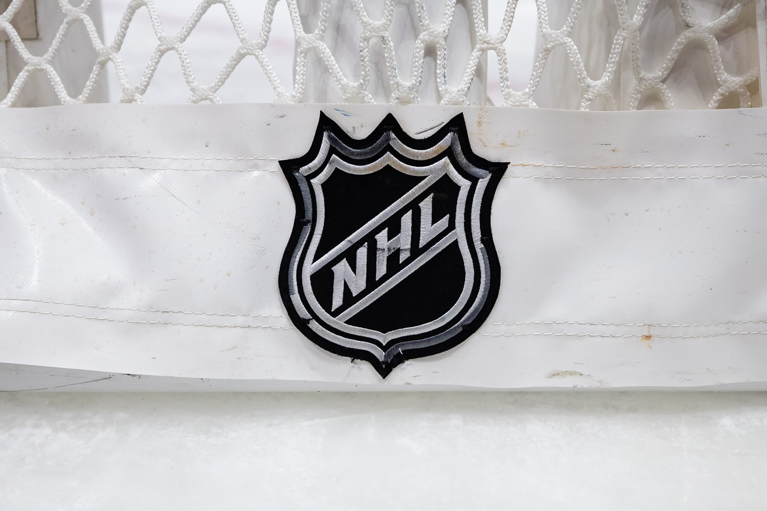 WASHINGTON, DC - JANUARY 10: The NHL logo is seen on the back of the net on the ice after the game between the Washington Capitals and the Boston Bruins at Capital One Arena on January 10, 2022 in Washington, DC. (Photo by Scott Taetsch/Getty Images)
