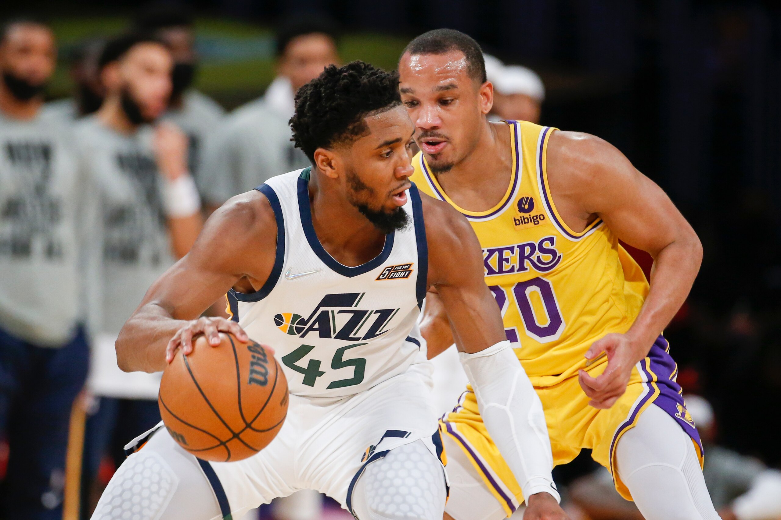 Utah Jazz guard Donovan Mitchell (45) is defended by Los Angeles Lakers guard Avery Bradley (20) during the second half of an NBA basketball game in Los Angeles, Monday, Jan. 17, 2022. The Lakers won 101-95. (AP Photo/Ringo H.W. Chiu)