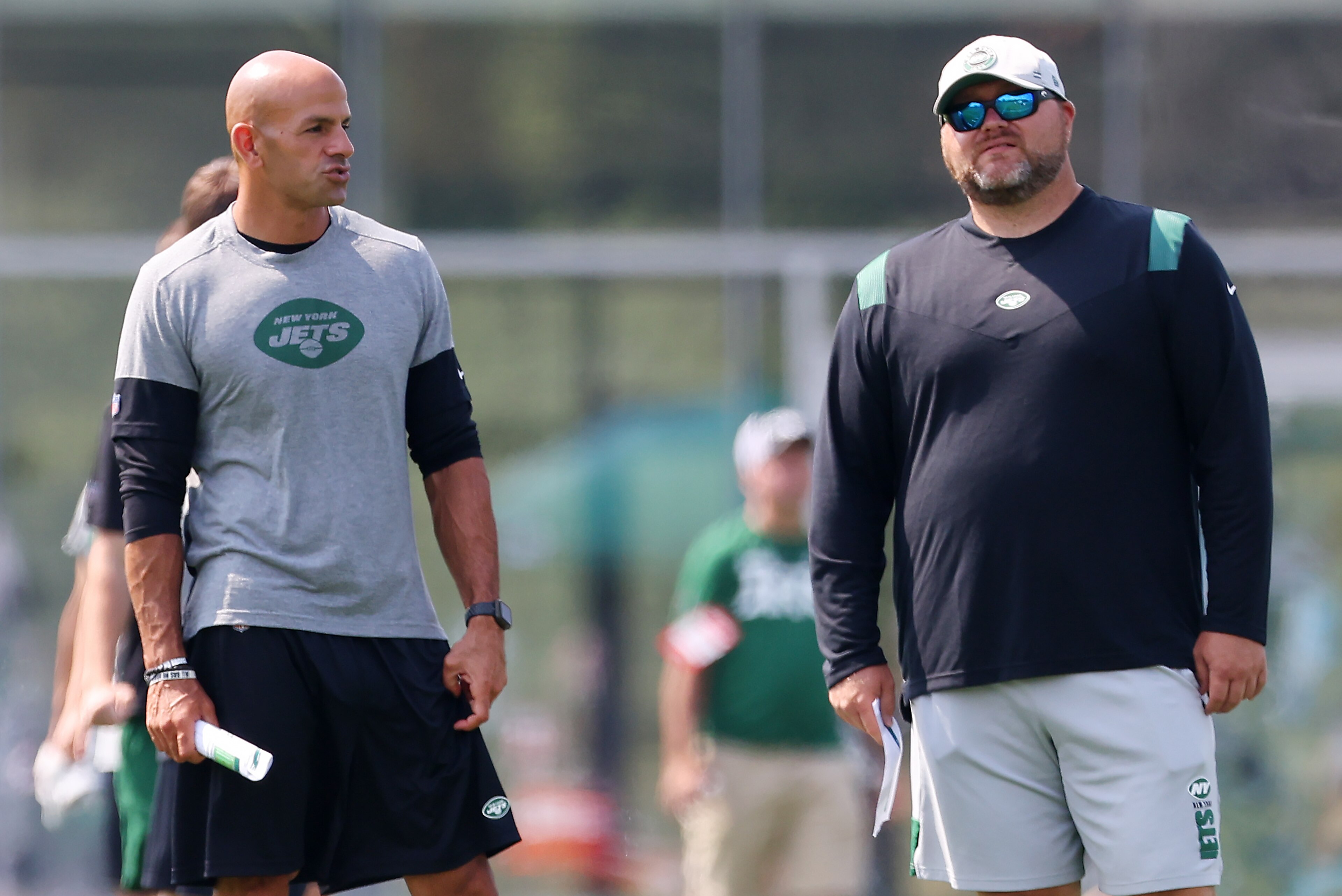 FLORHAM PARK, NJ - JULY 28: Head coach Robert Saleh, left, of the New York Jets talks with general manager Joe Douglas during morning practice at Atlantic Health Jets Training Center on July 28, 2021 in Florham Park, New Jersey. (Photo by Rich Schultz/Getty Images)