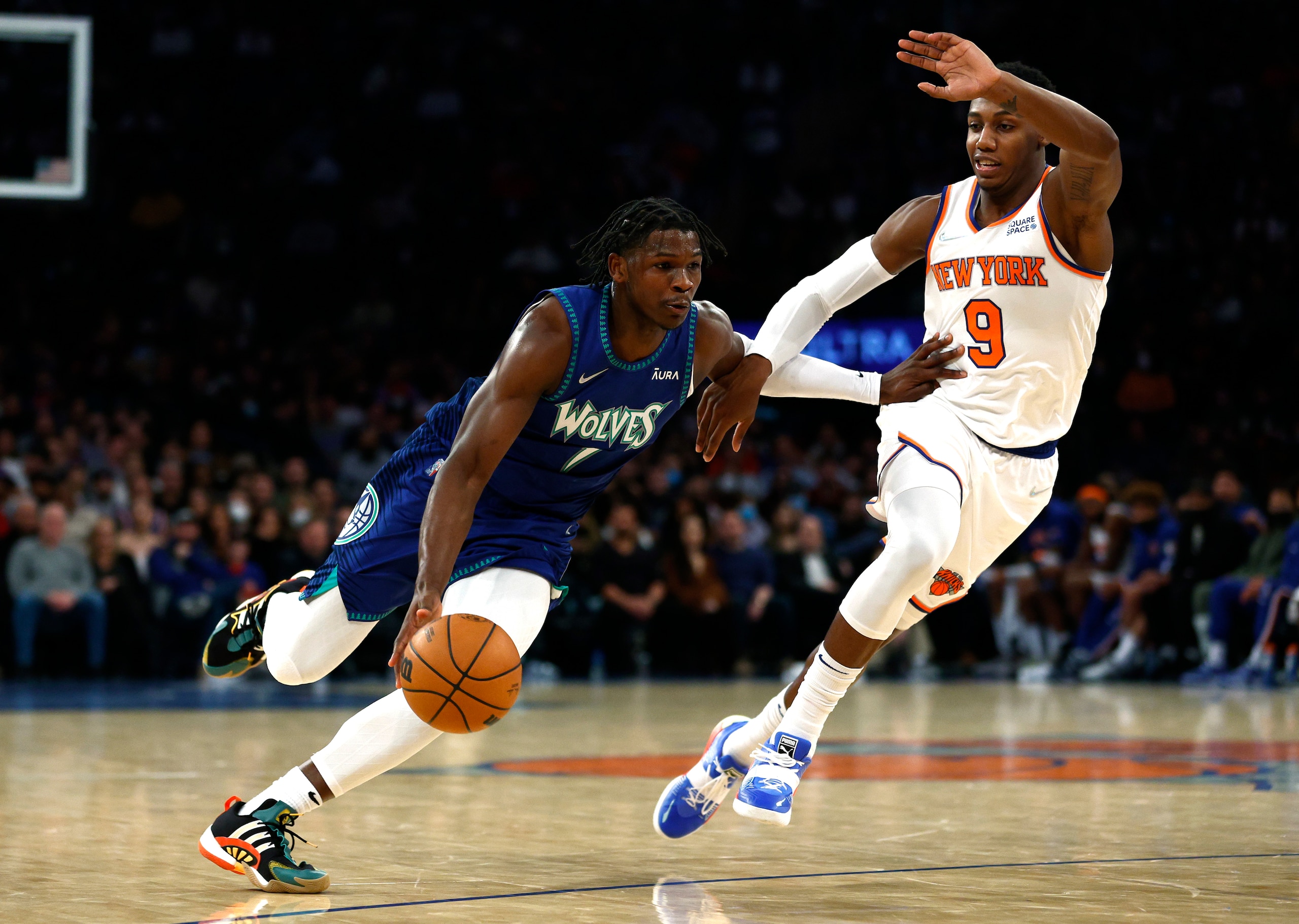NEW YORK, NEW YORK - JANUARY 18: Anthony Edwards #1 of the Minnesota Timberwolves dribbles as RJ Barrett #9 of the New York Knicks defends during the first half at Madison Square Garden on January 18, 2022 in New York City. NOTE TO USER: User expressly acknowledges and agrees that, by downloading and or using this photograph, User is consenting to the terms and conditions of the Getty Images License Agreement. (Photo by Sarah Stier/Getty Images)