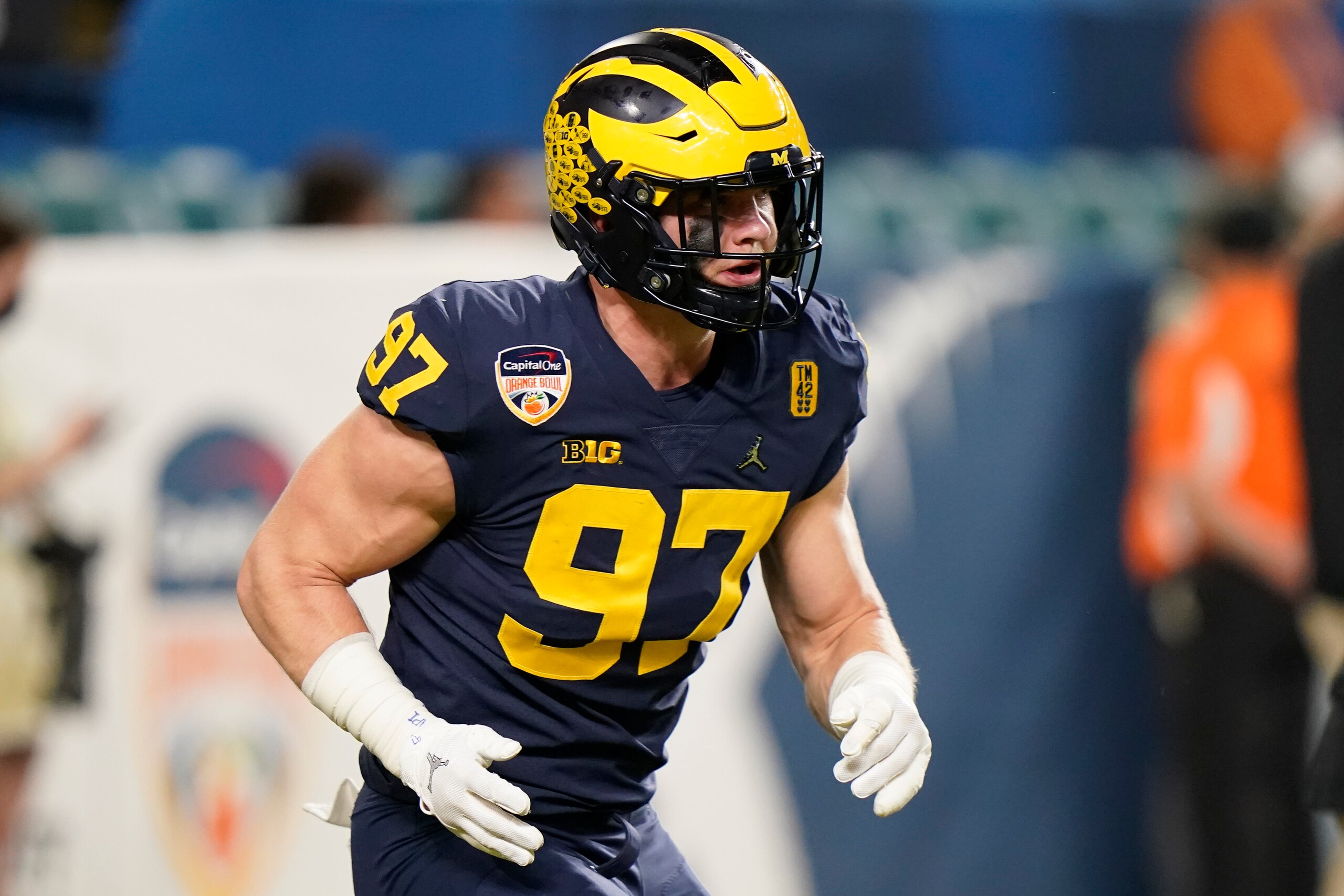 Michigan defensive end Aidan Hutchinson watches during warm ups before the Orange Bowl NCAA College Football Playoff semifinal game against Georgia, Friday, Dec. 31, 2021, in Miami Gardens, Fla. (AP Photo/Lynne Sladky)