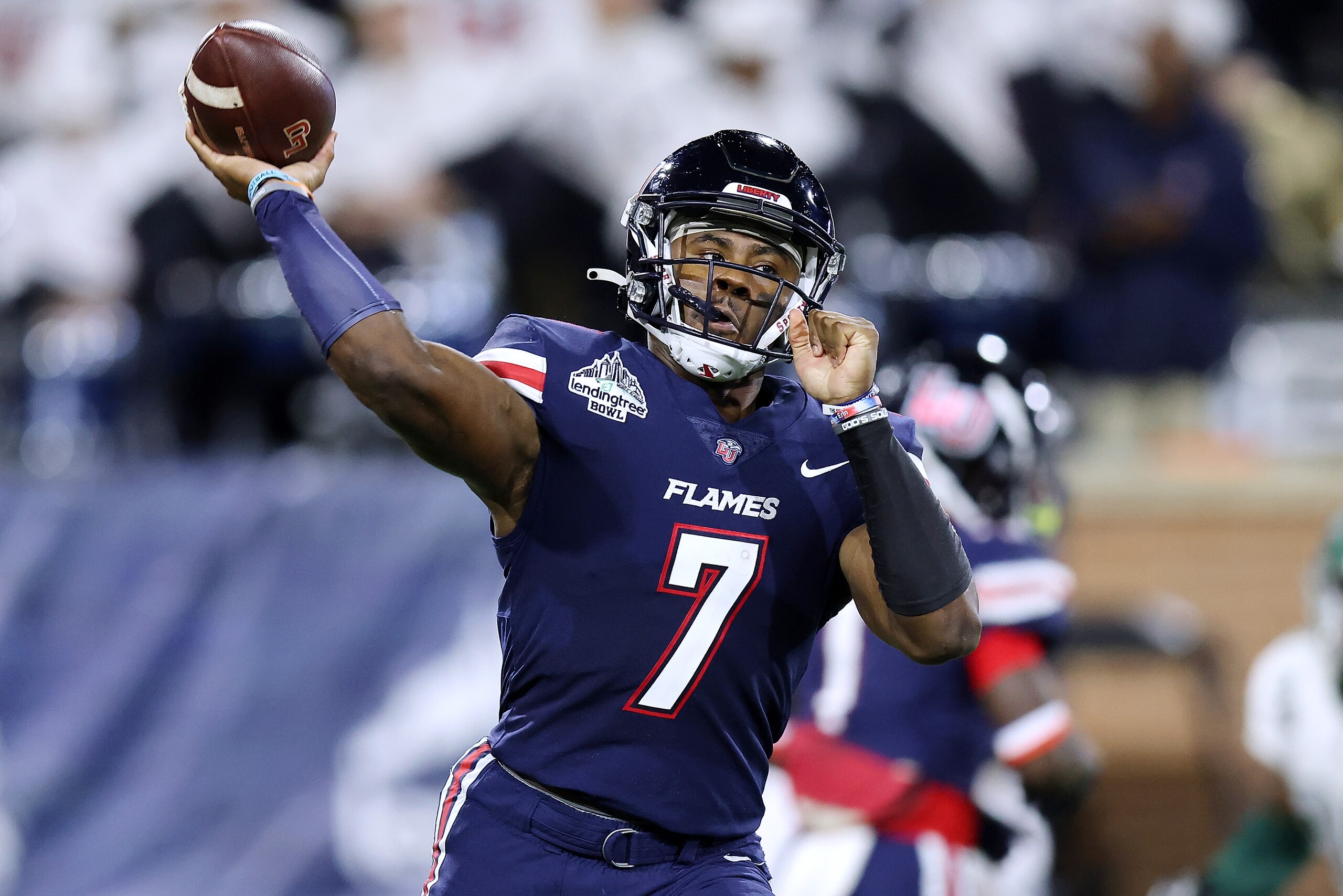 MOBILE, ALABAMA - DECEMBER 18: Malik Willis #7 of the Liberty Flames throws the ball during the first half of the LendingTree Bowl against the Eastern Michigan Eagles at Hancock Whitney Stadium on December 18, 2021 in Mobile, Alabama. (Photo by Jonathan Bachman/Getty Images)