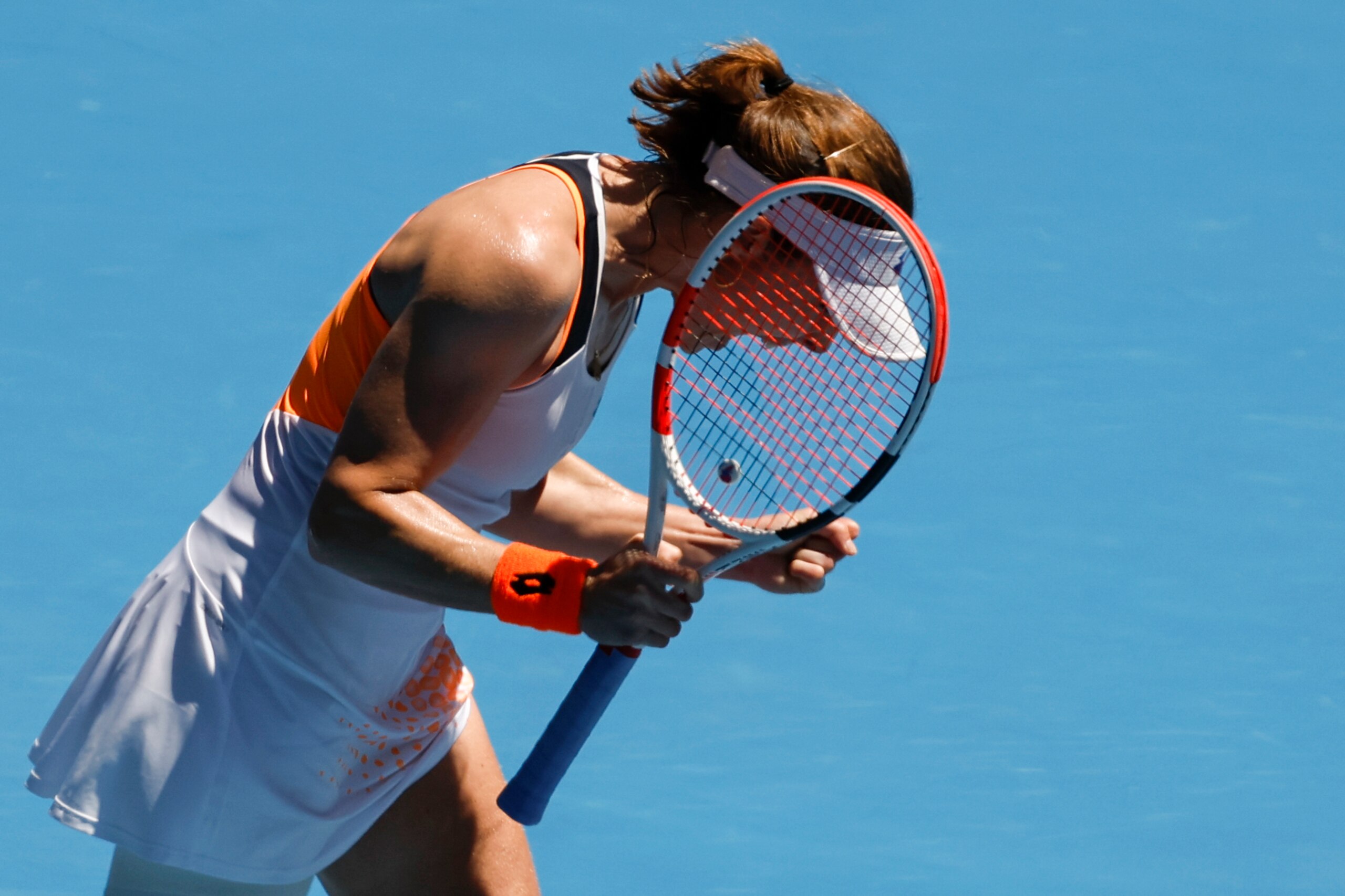 Alize Cornet of France celebrates after defeating Garbine Muguruza of Spain in their second round match at the Australian Open tennis championships in Melbourne, Australia, Thursday, Jan. 20, 2022. (AP Photo/Hamish Blair)