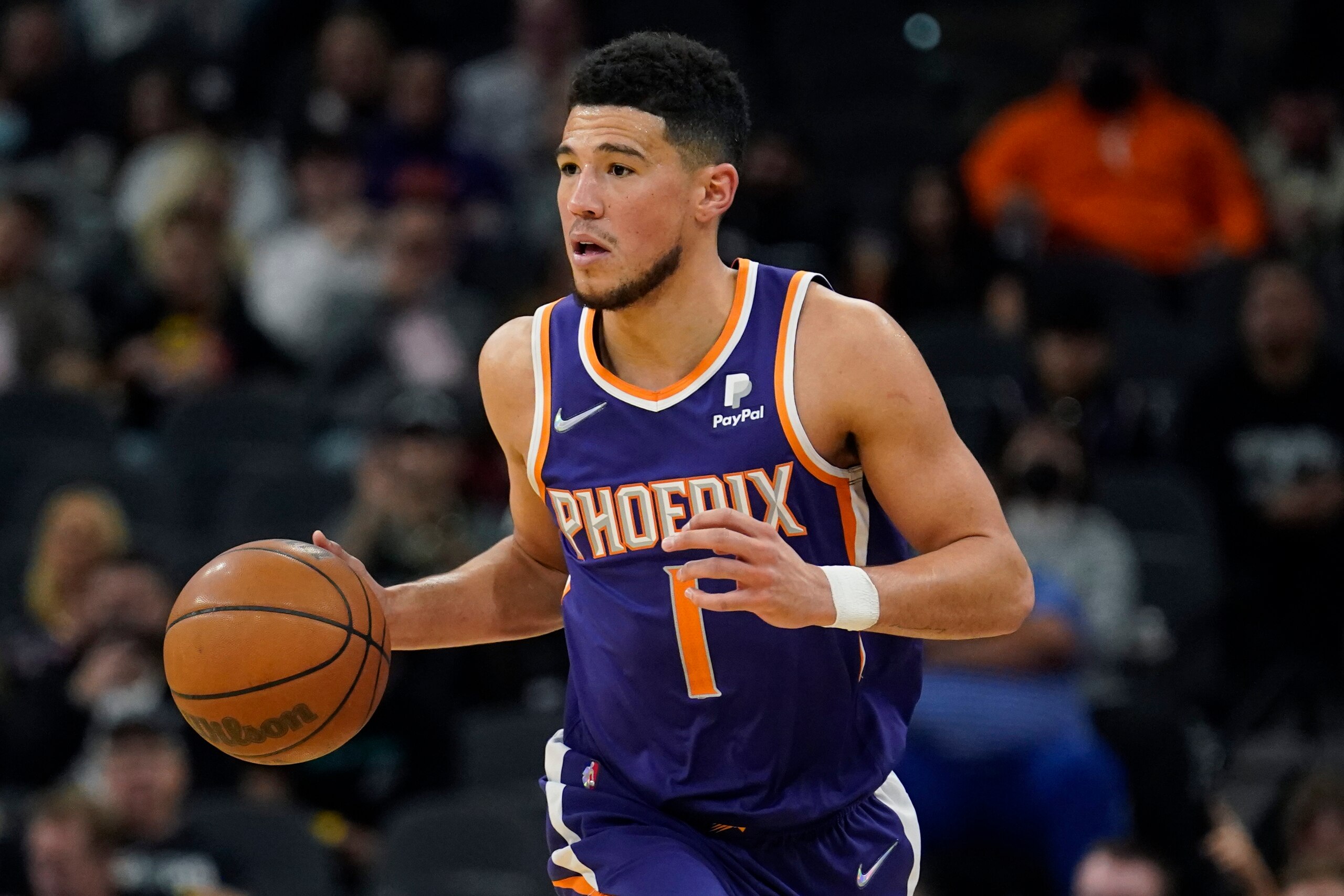 Phoenix Suns guard Devin Booker (1) moves the ball upcourt against the San Antonio Spurs during the second half of an NBA basketball game, Monday, Jan. 17, 2022, in San Antonio. (AP Photo/Eric Gay) Phoenix Suns guard Devin Booker (1) moves the ball upcourt against the San Antonio Spurs during the second half of an NBA basketball game, Monday, Jan. 17, 2022, in San Antonio. (AP Photo/Eric Gay)