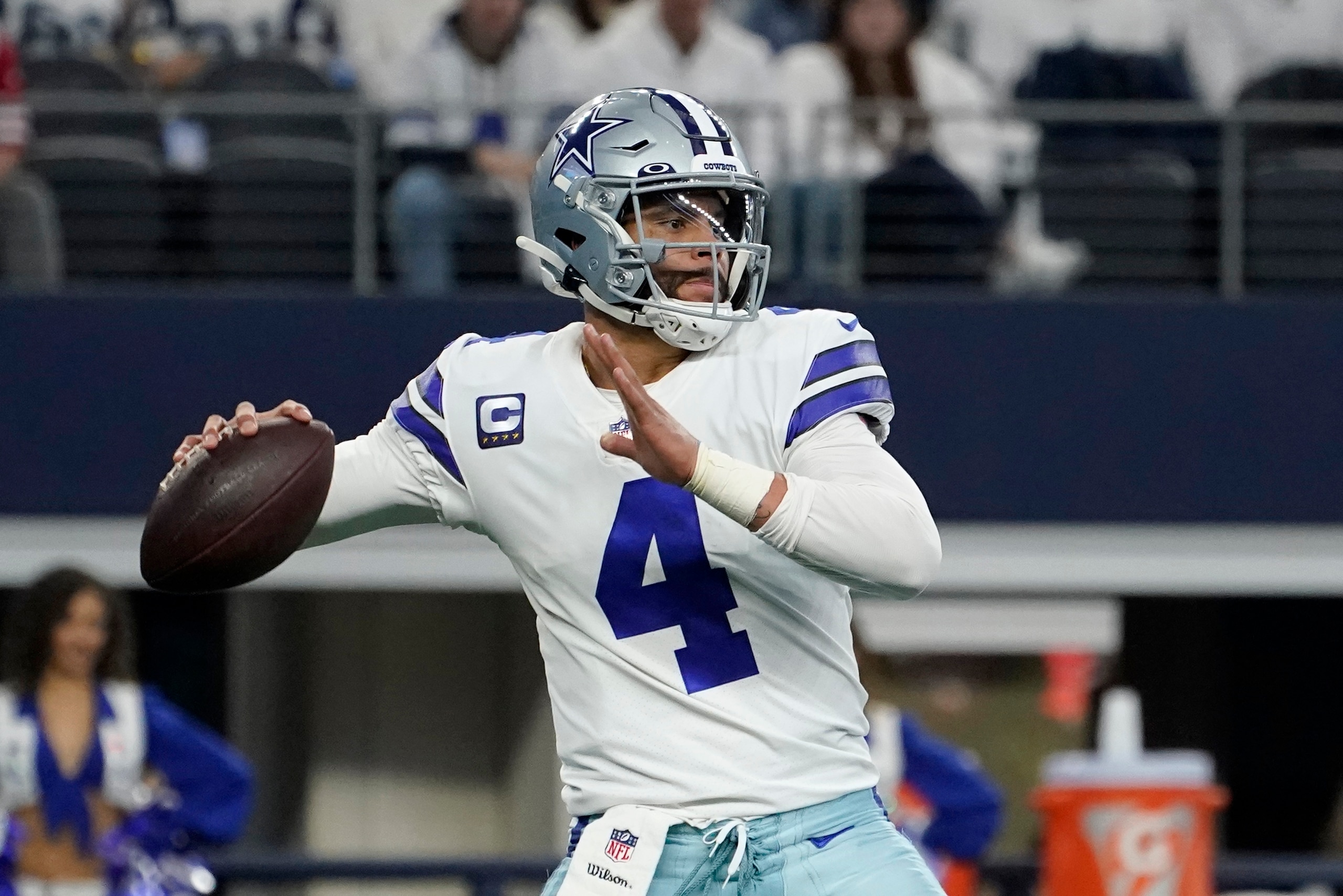 Dallas Cowboys quarterback Dak Prescott (4) looks before throwing a pass in the first half of an NFL wild-card playoff football game against the San Franciso 49ers in Arlington, Texas, Sunday, Jan. 16, 2022. (AP Photo/Tony Gutierrez)