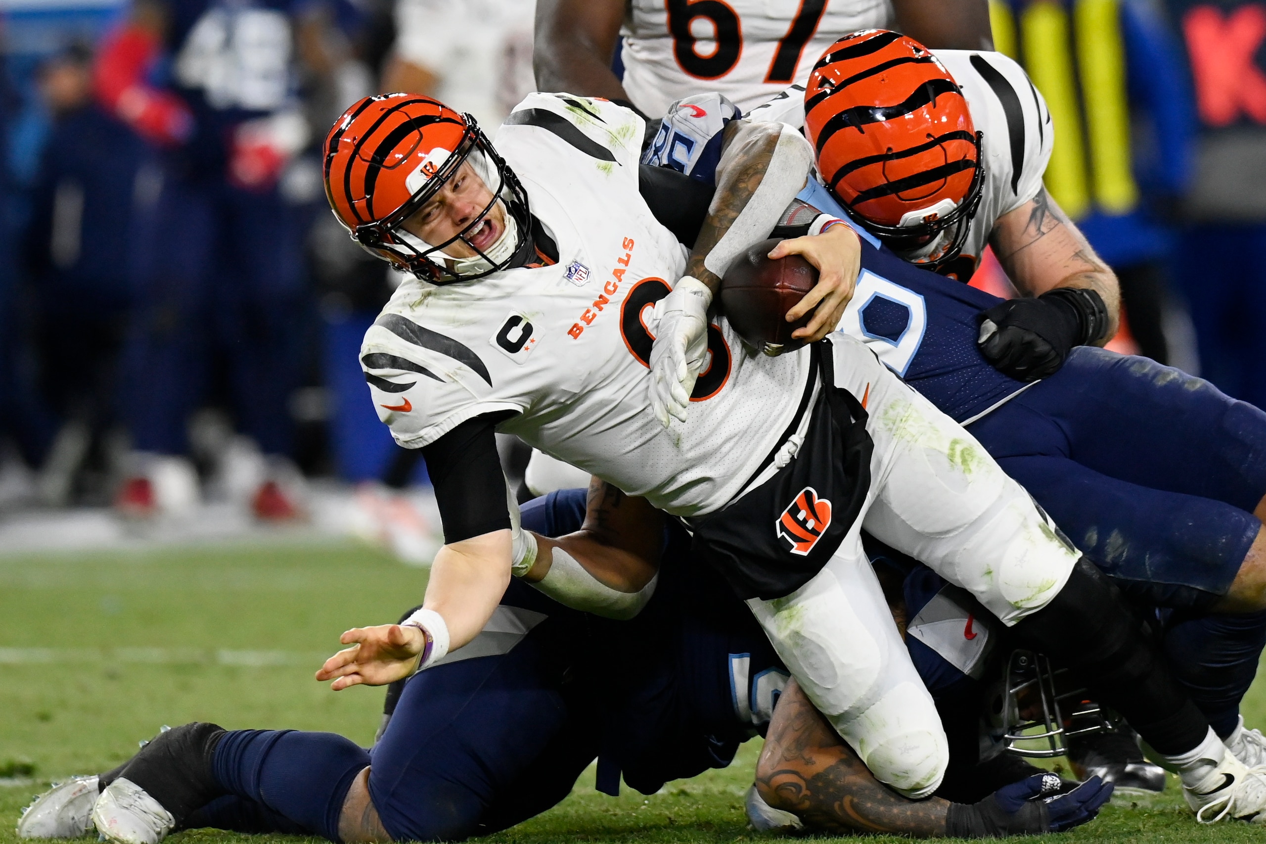 Tennessee Titans' Anthony Rush and Harold Landry sack Cincinnati Bengals quarterback Joe Burrow (9) during the second half of an NFL divisional round playoff football game, Saturday, Jan. 22, 2022, in Nashville, Tenn. (AP Photo/Mark Zaleski) Tennessee Titans' Anthony Rush and Harold Landry sack Cincinnati Bengals quarterback Joe Burrow (9) during the second half of an NFL divisional round playoff football game, Saturday, Jan. 22, 2022, in Nashville, Tenn. (AP Photo/Mark Zaleski)