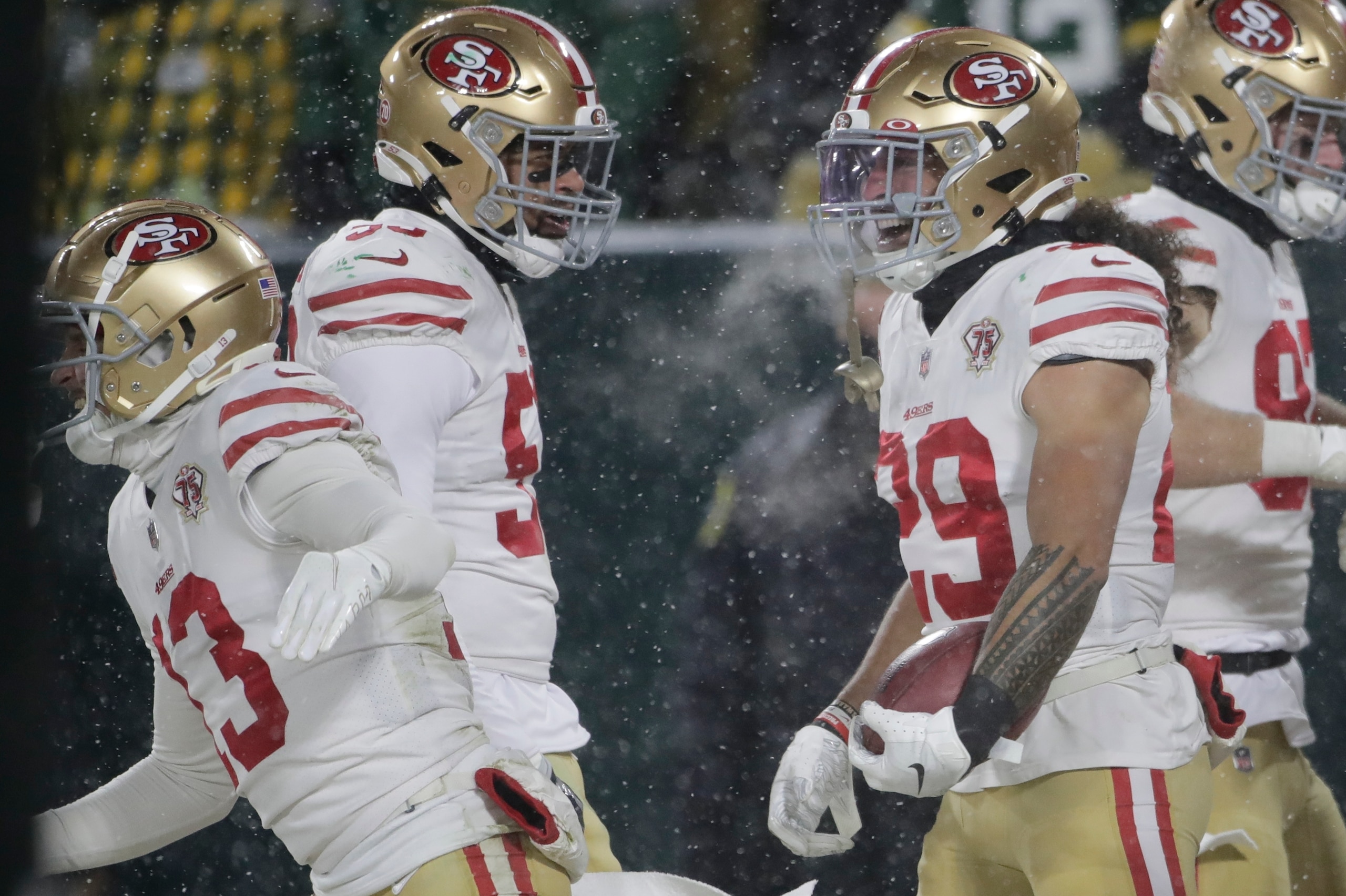 San Francisco 49ers' Talanoa Hufanga reacts after running a blocked punt in for a touchdown during the second half of an NFC divisional playoff NFL football game against the Green Bay Packers Saturday, Jan. 22, 2022, in Green Bay, Wis. (AP Photo/Aaron Gash) San Francisco 49ers' Talanoa Hufanga reacts after running a blocked punt in for a touchdown during the second half of an NFC divisional playoff NFL football game against the Green Bay Packers Saturday, Jan. 22, 2022, in Green Bay, Wis. (AP Photo/Aaron Gash)